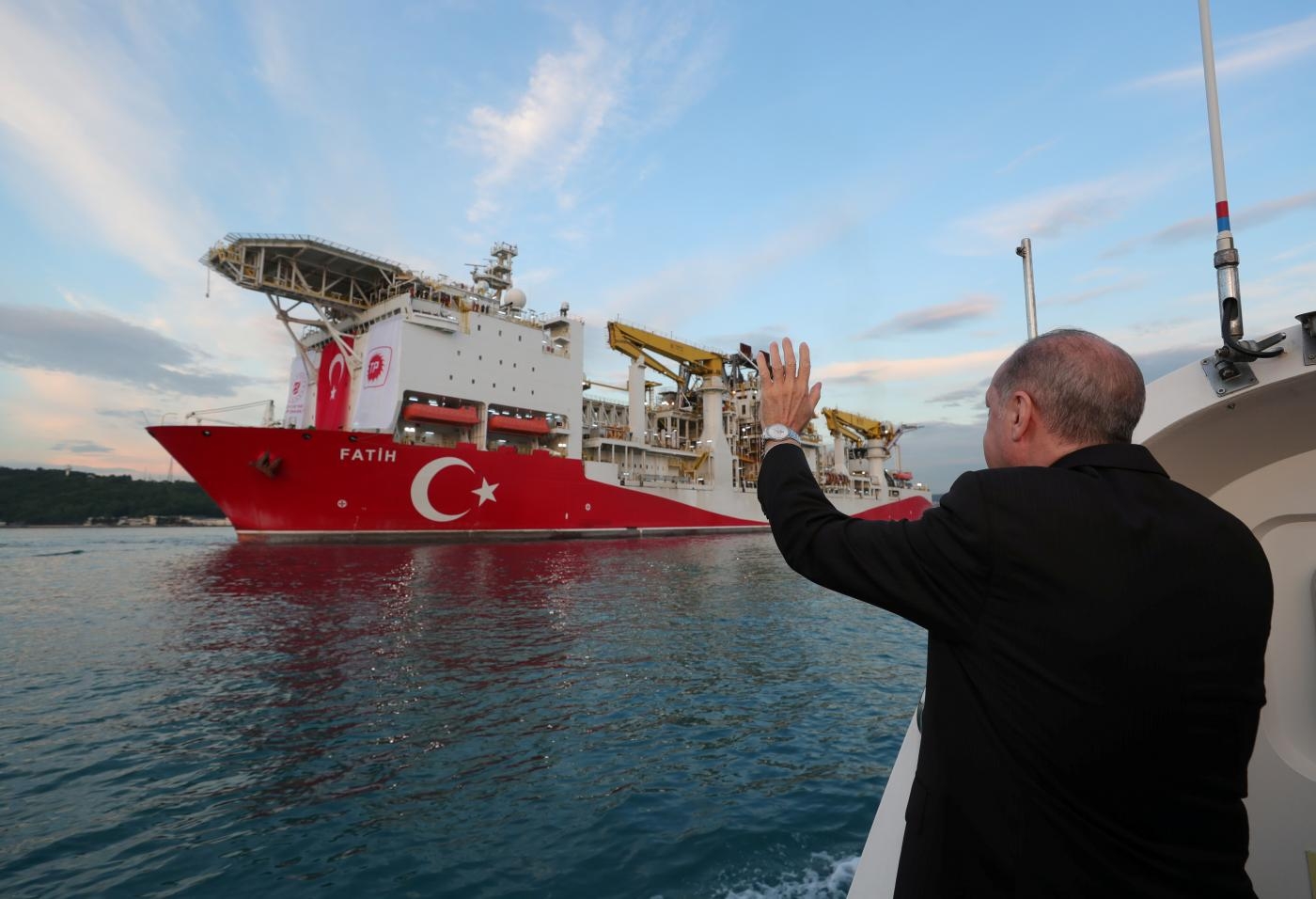 Turkish President Recep Tayyip Erdogan waves as Turkey's drilling vessel Fatih departs for the Black Sea during a ceremony in Istanbul