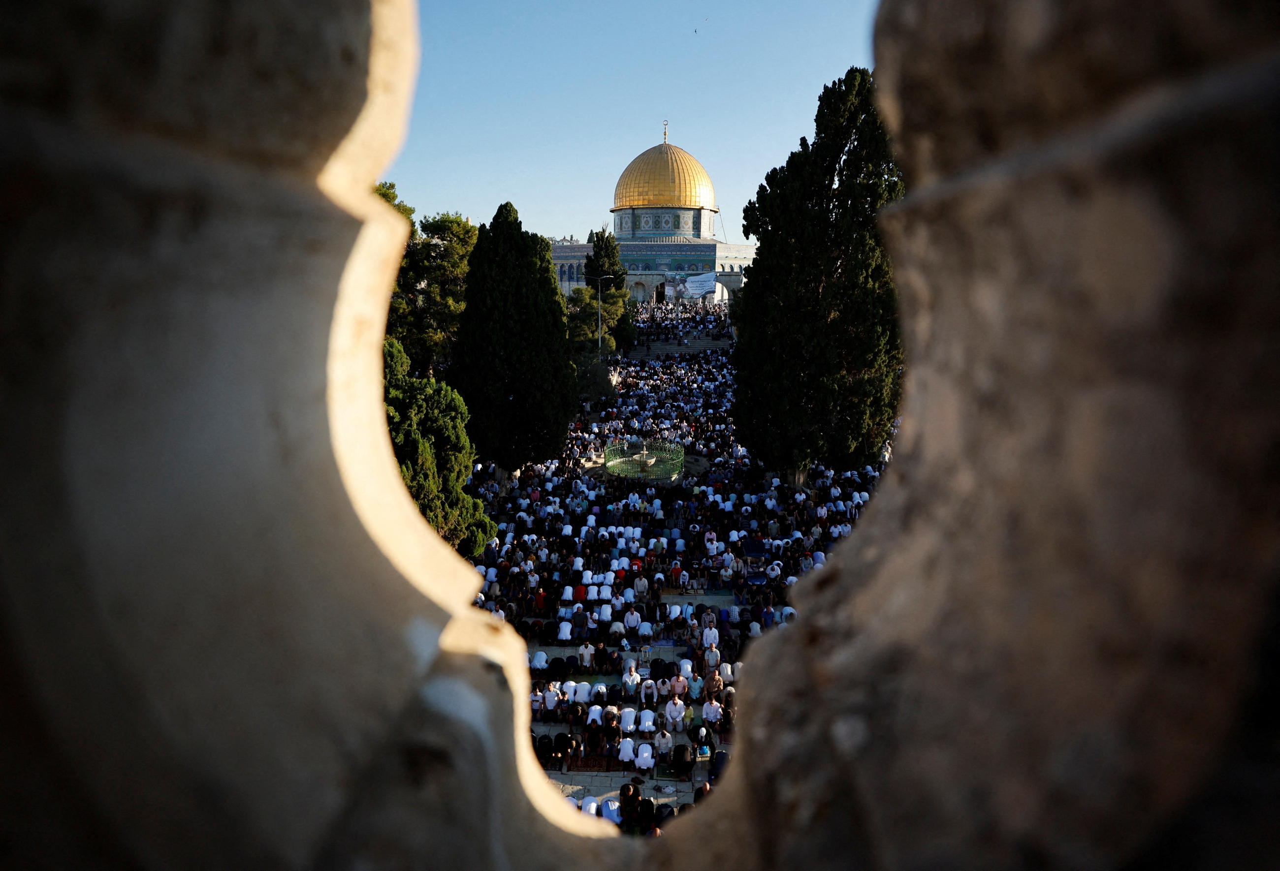 Palestinians pray on the first day of Muslim holiday of Eid al-Adha in al-Aqsa Mosque in Jerusalem's Old City, 9 July 2022 (Reuters)