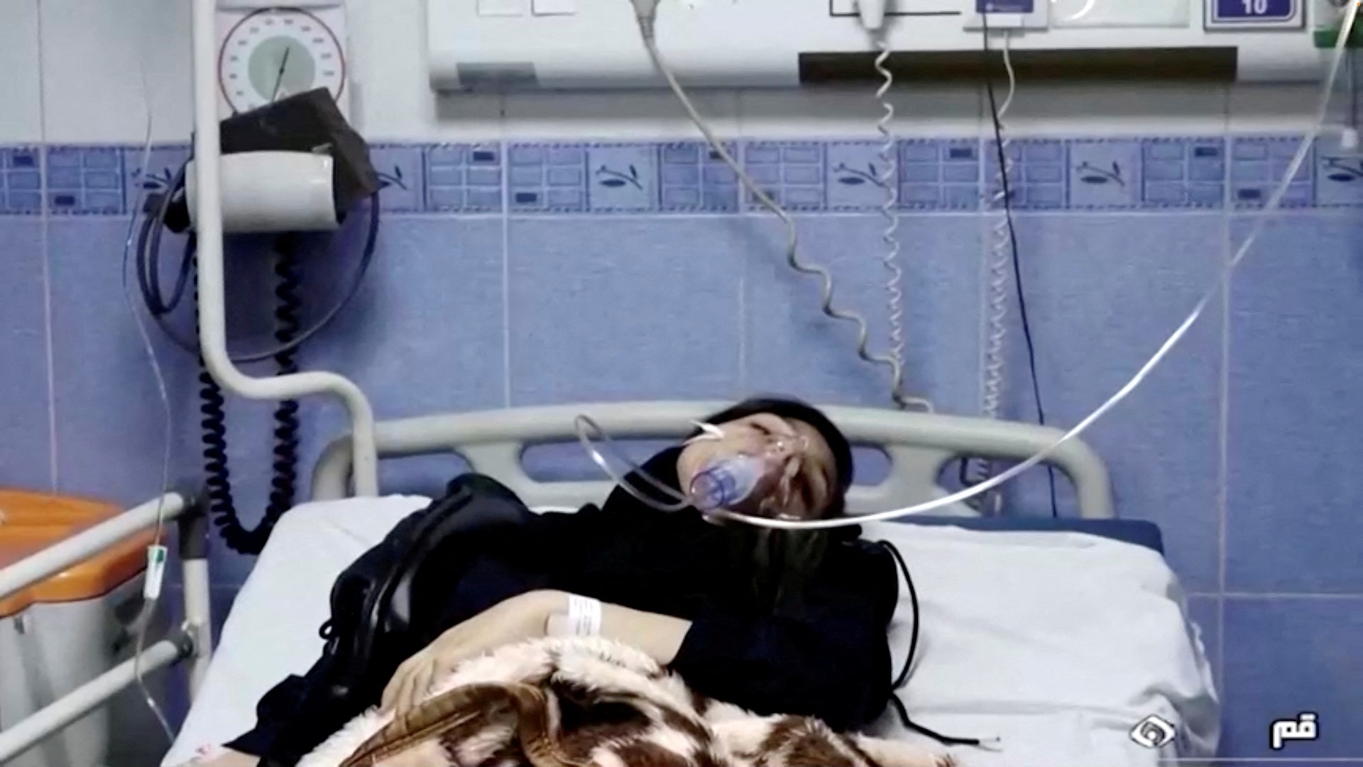 A young woman lies in hospital after reports of poisoning at an unspecified location in Iran in this still image from video from 2 March (Reuters)
