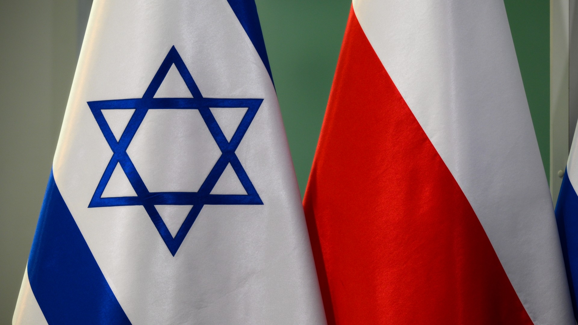 Israeli and Polish flags are seen at the foreign ministry in Warsaw, Poland on 22 March (Reuters)