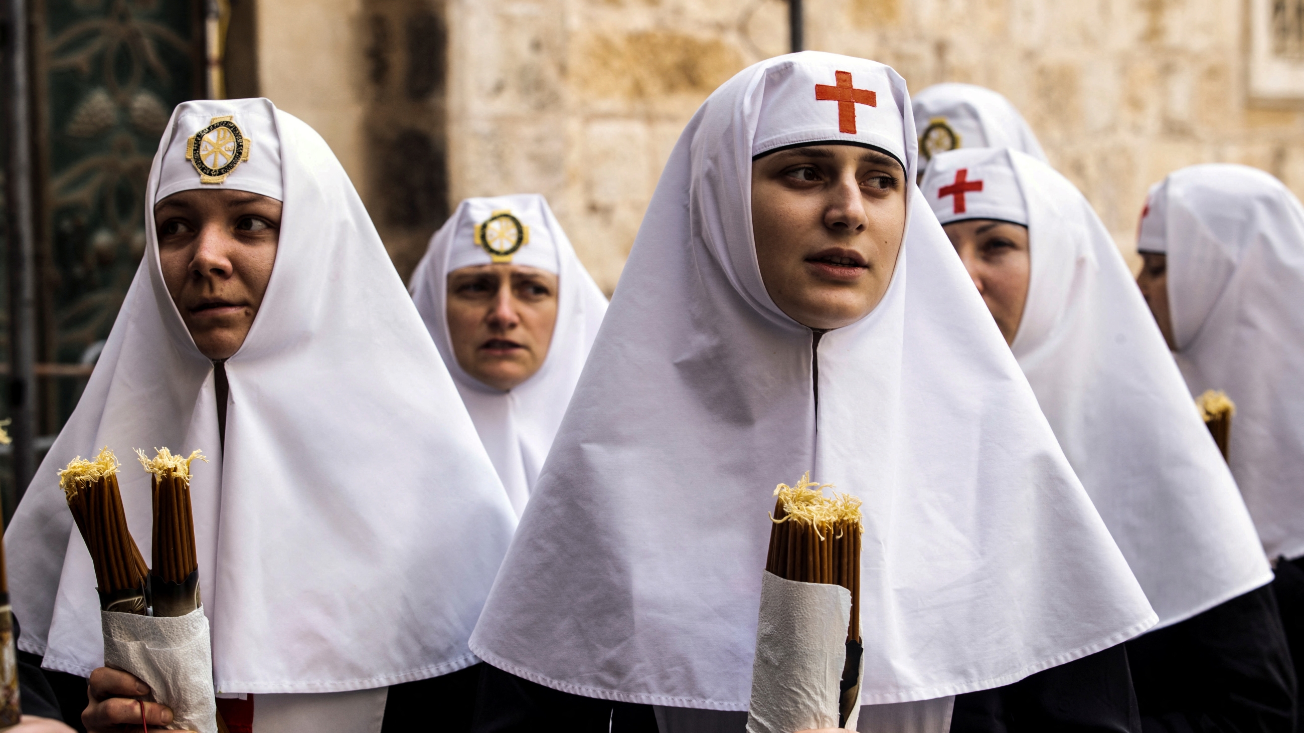 Nuns hold candles as Orthodox Christian worshippers attend the Holy Fire ceremony at the Church of the Holy Sepulchre in Jerusalem's Old City on 15 April 2023 (Reuters)