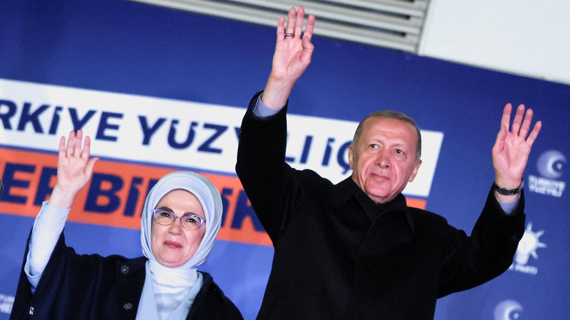 Turkish President Recep Tayyip Erdogan, accompanied by his wife Ermine Erdogan, greets supporters at the AKP headquarters in Ankara (Reuters)