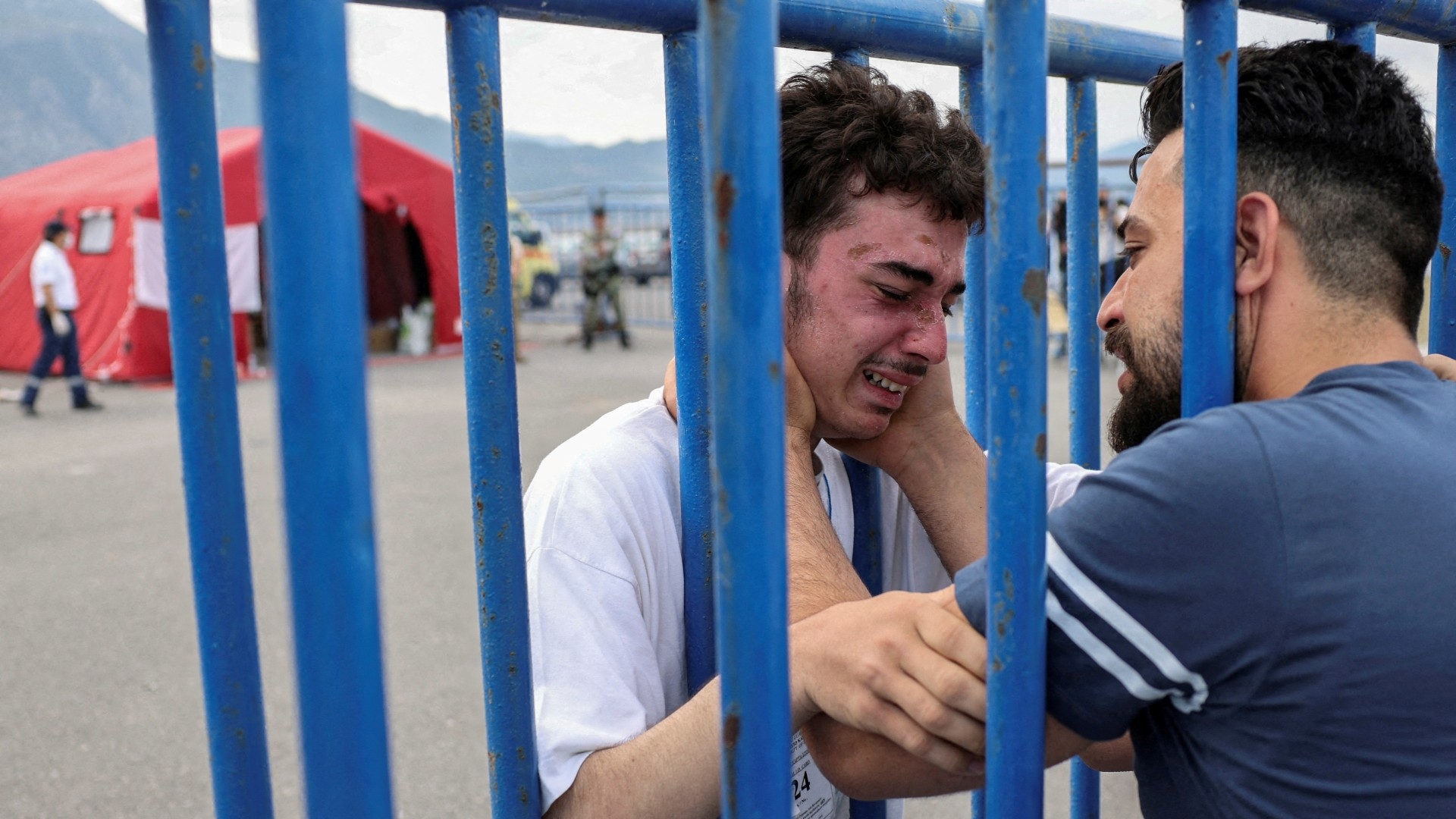 A Syrian survivor cries as he reunites with his brother at the port of Kalamata, Greece, 16 June (Reuters)