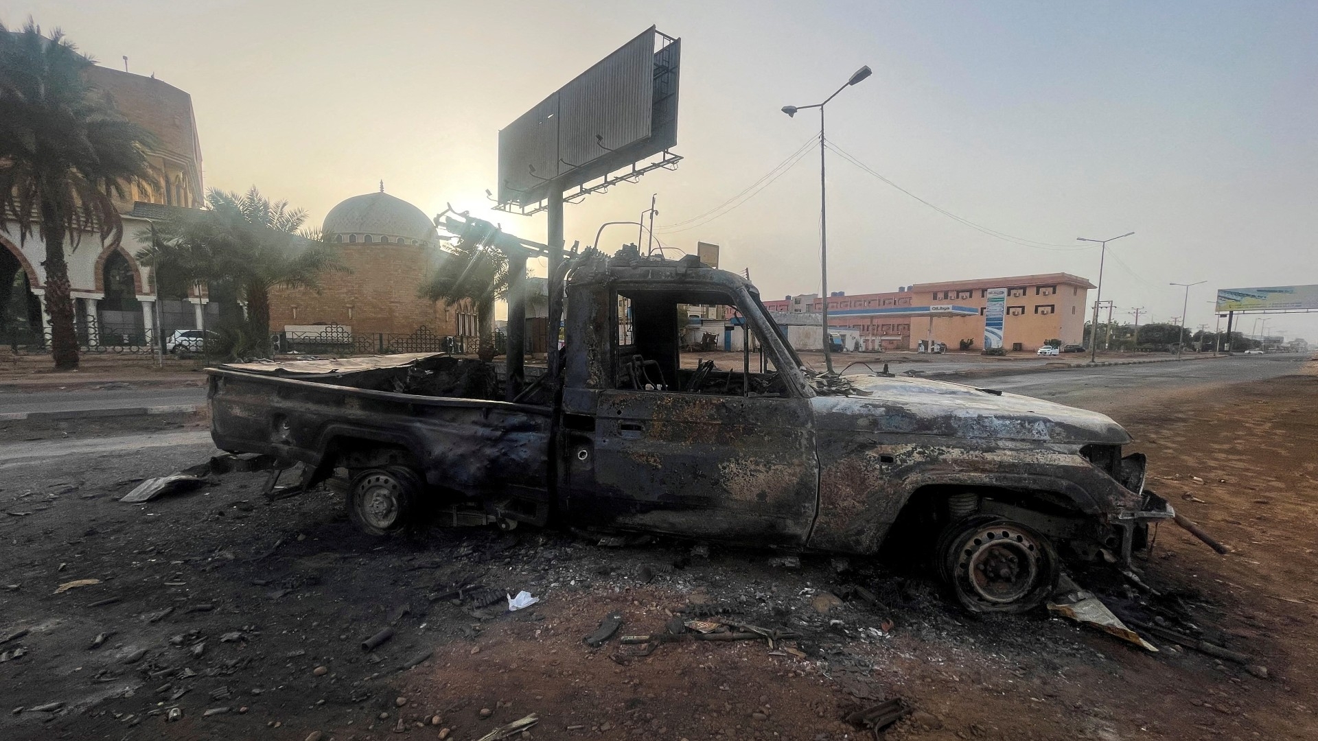 A burned vehicle is seen in Khartoum, 26 April (Reuters)