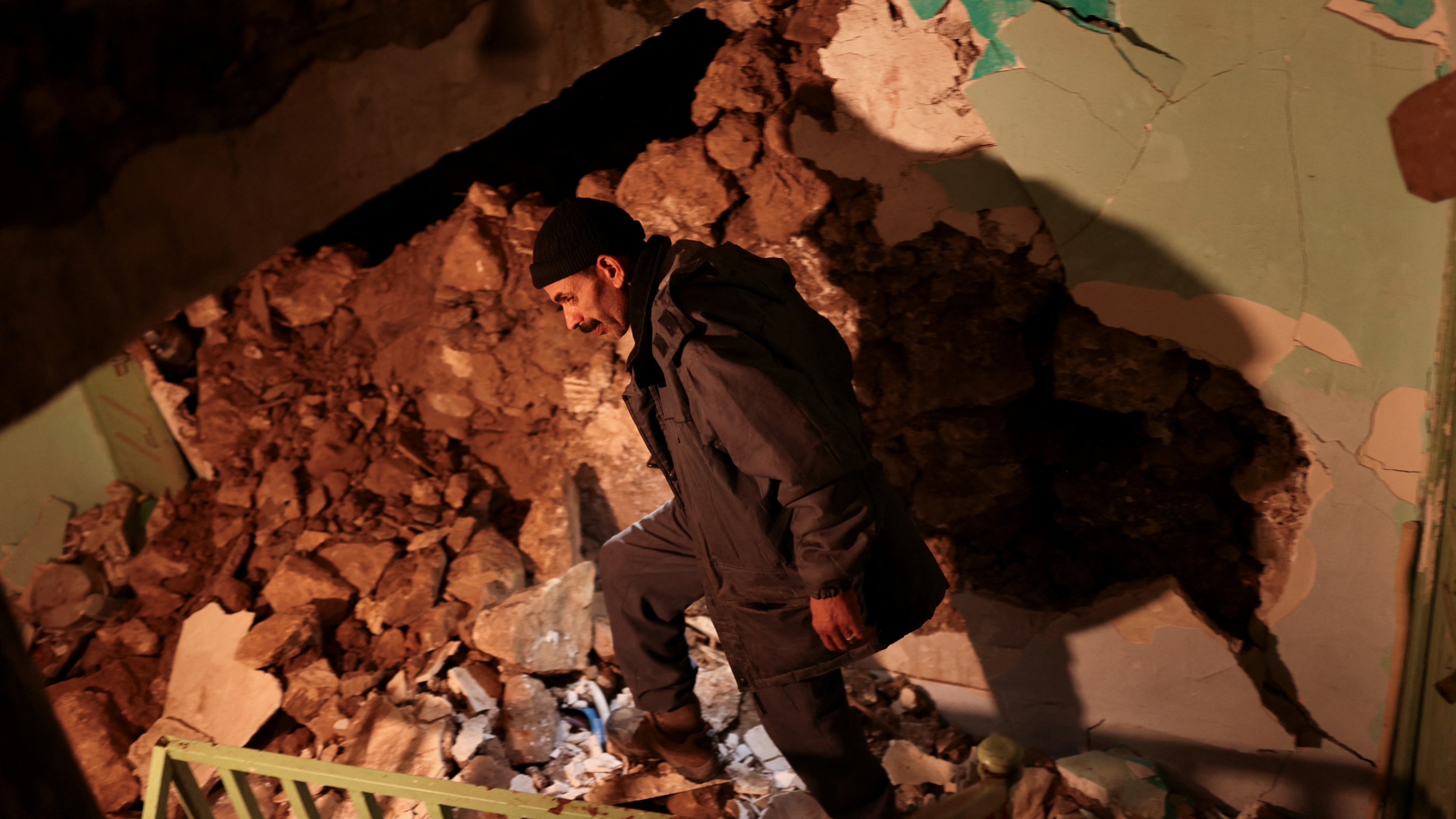 A man walks inside his damaged house in Moulay Brahim village, in the province of Al Haouz, following a powerful earthquake in Morocco, 9 September 2023 (Reuters)