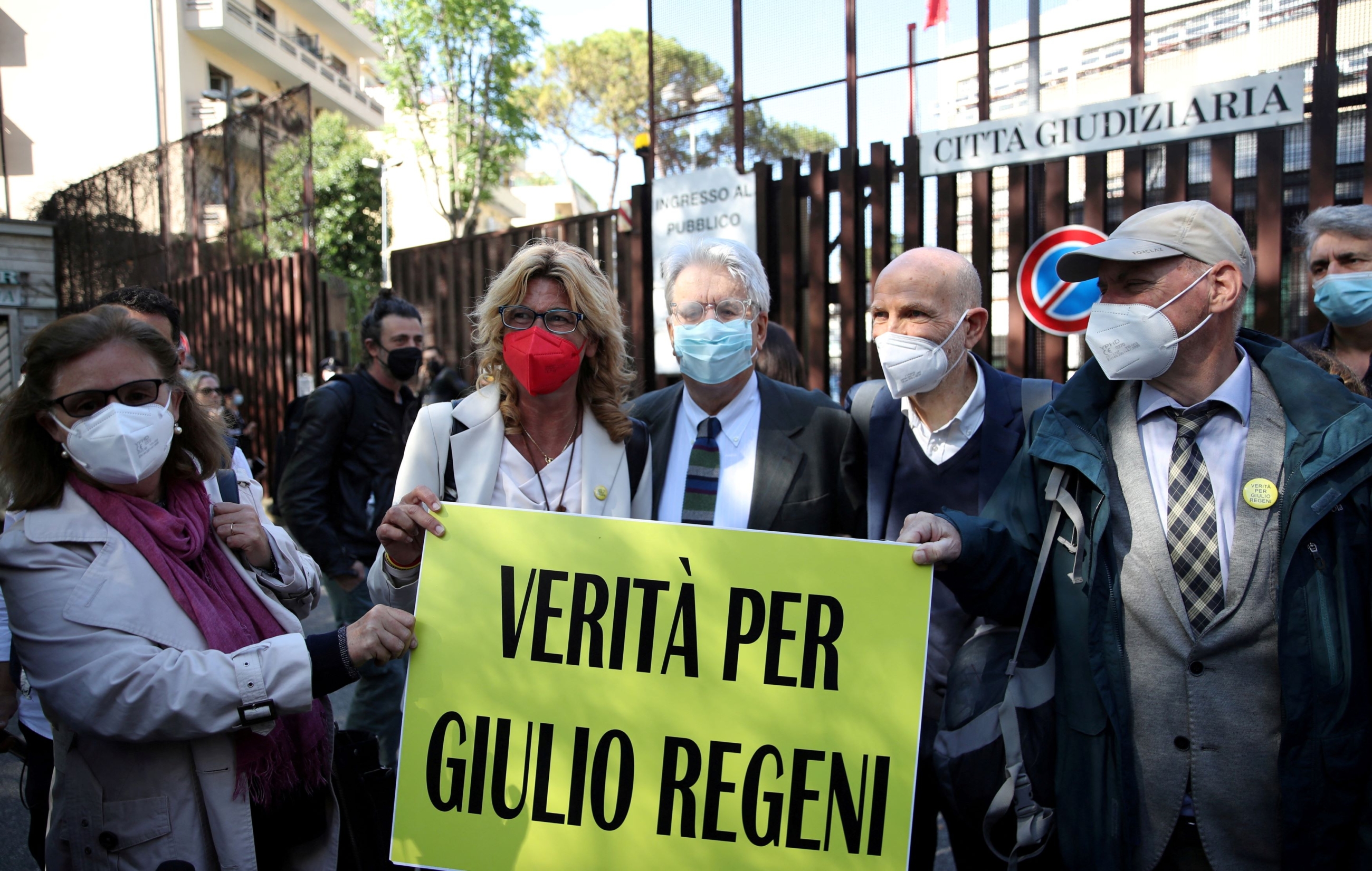  Paola and Claudio Regeni stand outside the courthouse with their lawyer Alessandra Ballerini before the pre-trial hearing to decide if four high-ranking Egyptian security officers should go on trial for the 2016 Cairo abduction, torture and killing of their son Giulio Regeni, a student, in Rome, Italy, May 25, 2021. Sign reads, "Truth for Giulio Regeni" (Reuters)