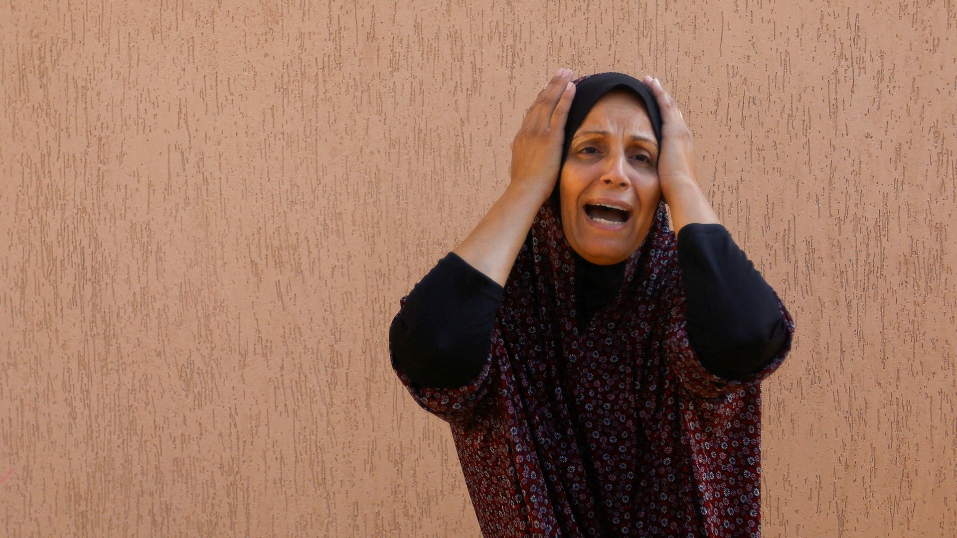 A Palestinian woman reacts in the aftermath of Israeli strikes, in Khan Younis in the southern Gaza Strip, 14 October (Reuters)