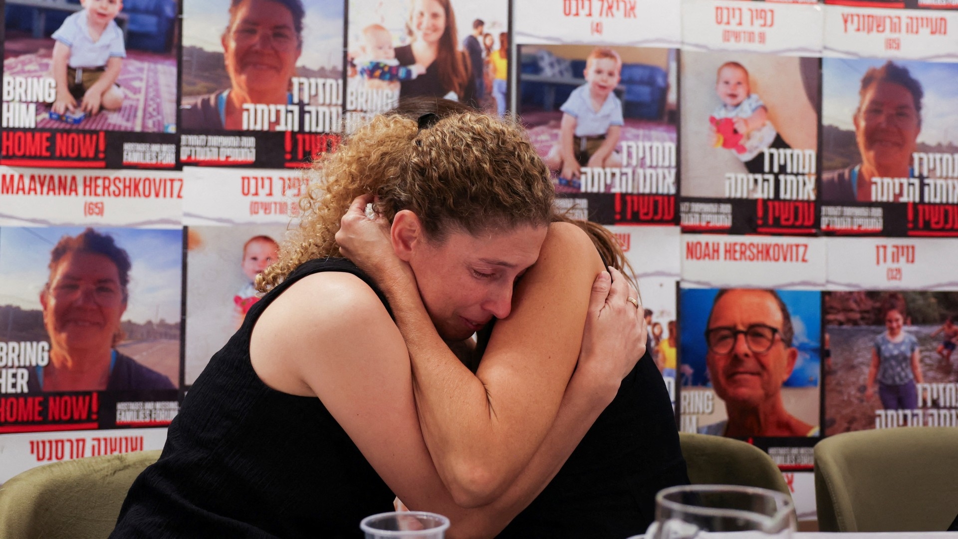Relatives of captive Israelis comfort each other in Tel Aviv, on 14 October (Reuters)