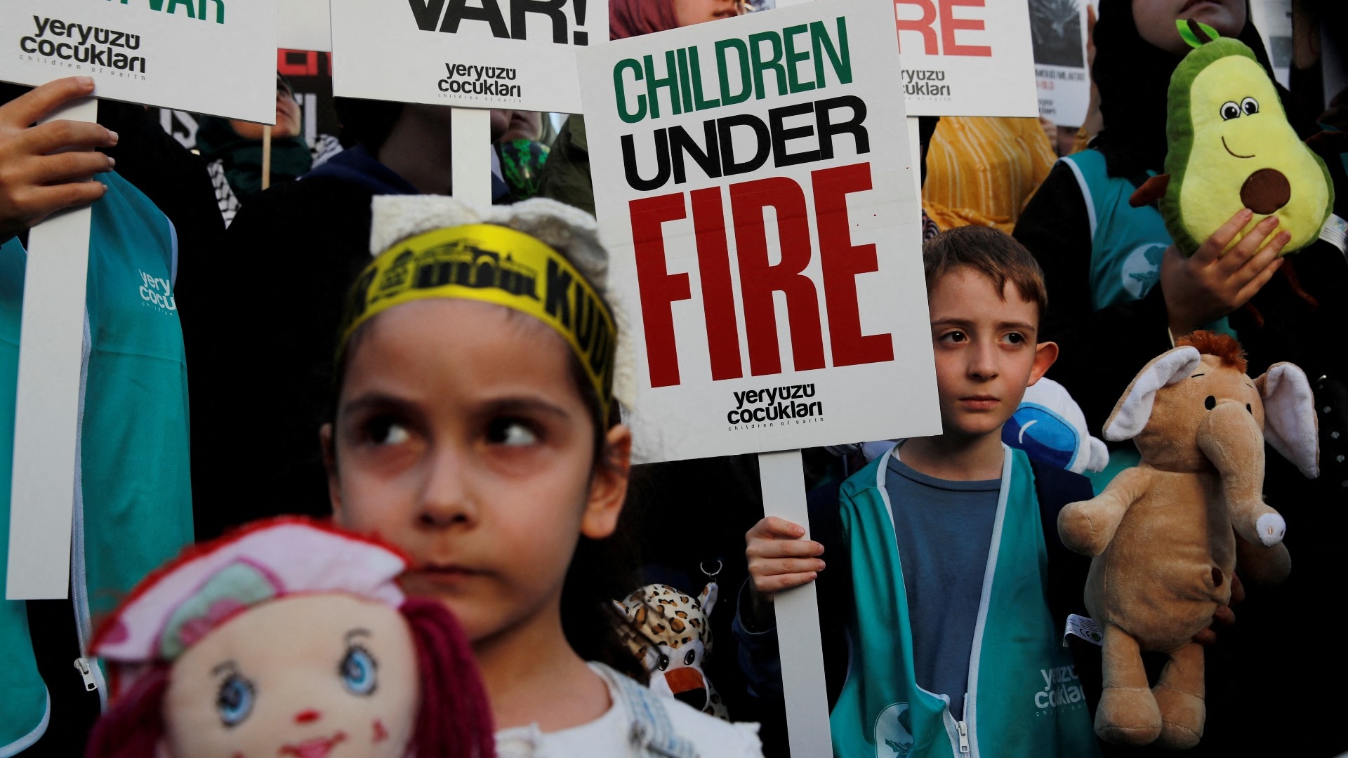 Children holding toys and signs take part in a protest against Israel near the Israeli consulate in Istanbul on 21 October (Reuters)