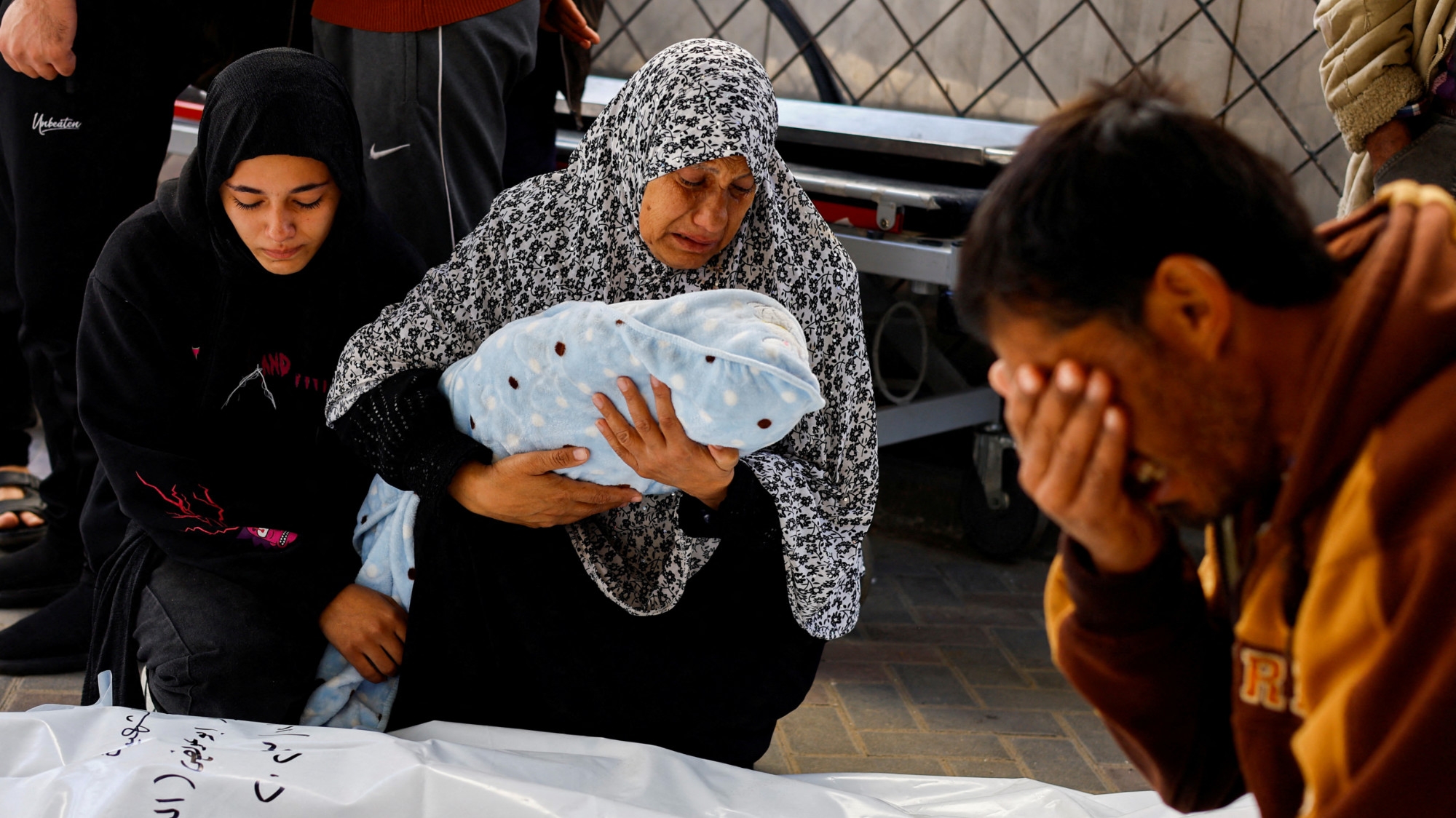 The grandmother of Palestinian baby Idres Al-Dbari, who was born during the war and killed in an Israeli strike, reacts at Abu Yousef al-Najjar hospital in Rafah in the southern Gaza Strip 12 December 2023 (Reuters/Mohammed Salem)