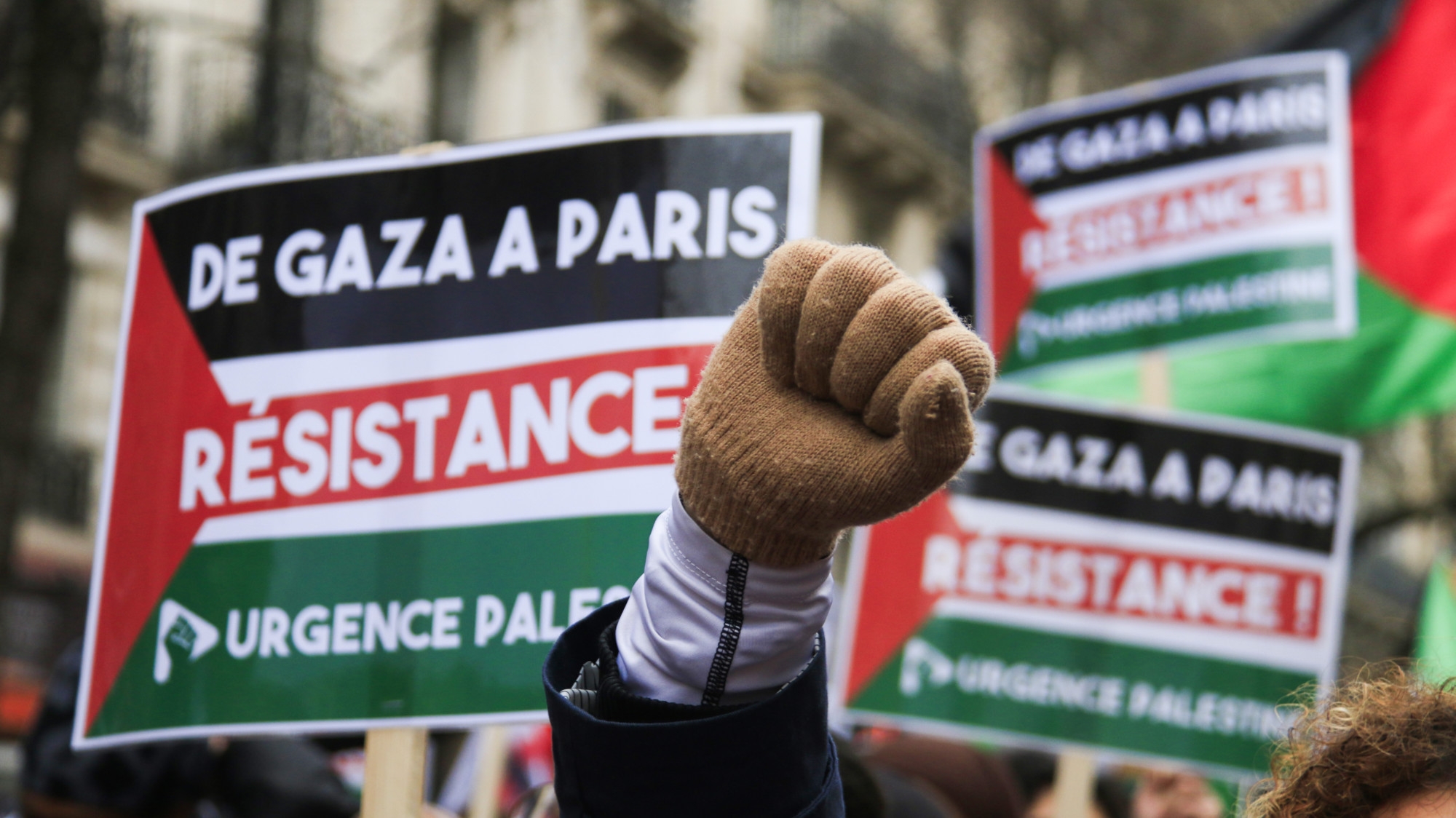 A protester raises her fist during a march in favour of a ceasefire in Gaza in the French capital Paris on 13 January 2024 (Quentin de Groeve/Hans Lucas via Reuters)