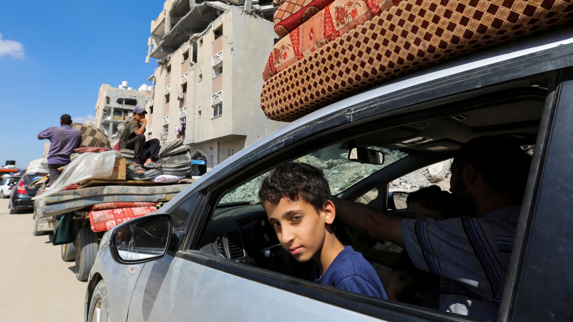 Displaced Palestinians make their way as they flee Hamad City following an Israeli displacement order in Khan Younis in the southern Gaza Strip 11 August 2024 (Reuters/Hatem Khaled)