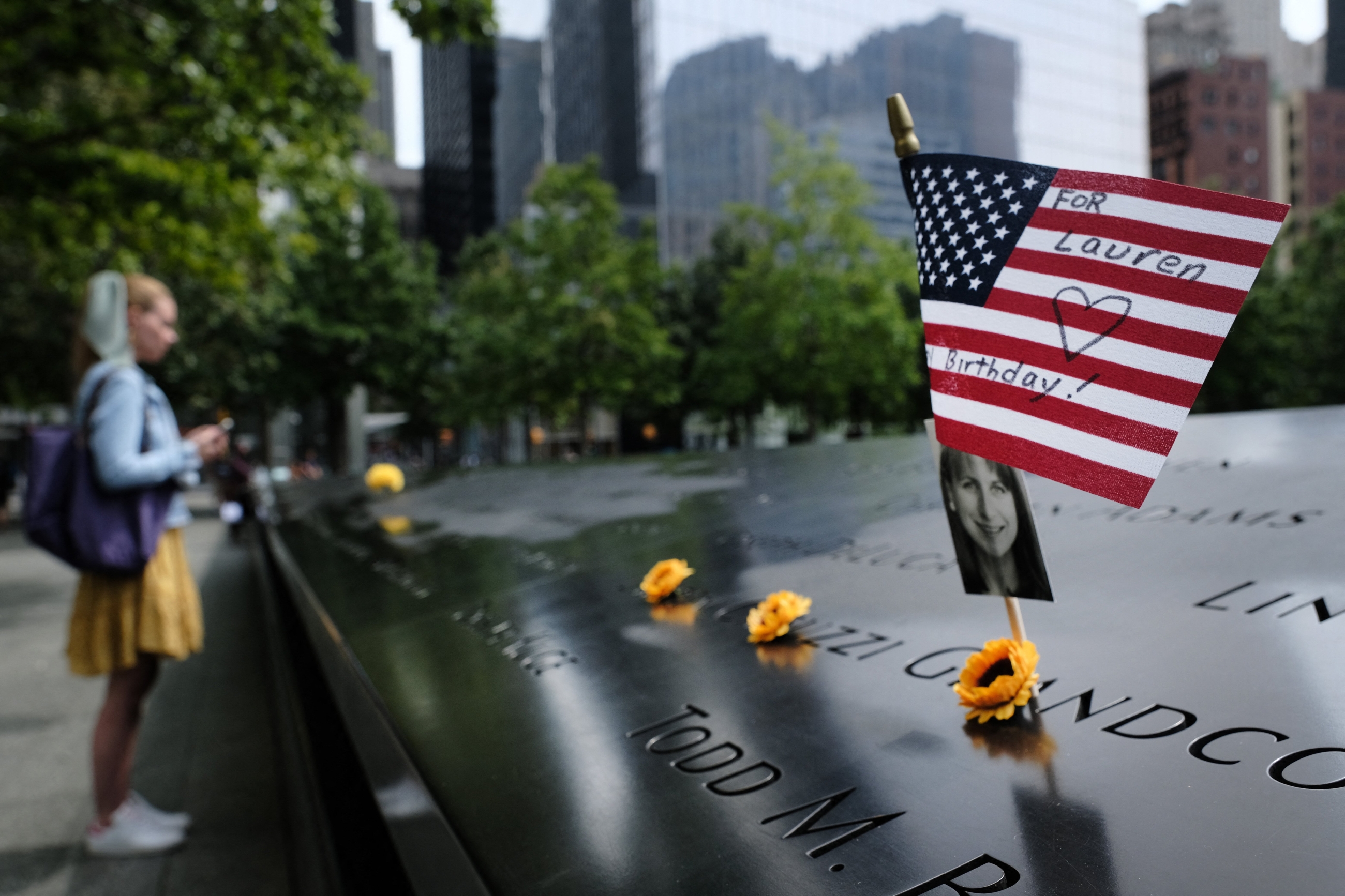 A US flag is placed near a victim's name at the September 11 Memorial at Ground Zero 
