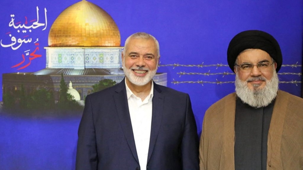 Hezbollah leader Hasan Nasrallah (R) posing for a picture with Ismail Haniyeh following a meeting (Al-Manar/AFP)