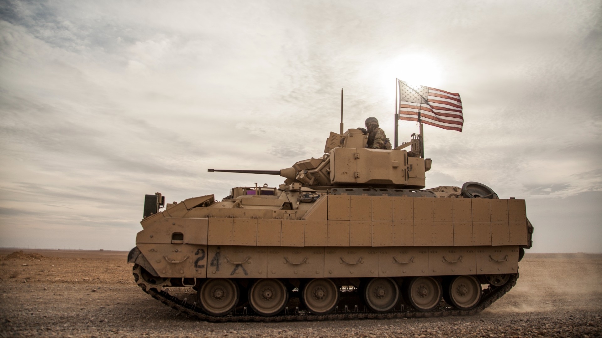 American soldiers drive a Bradley fighting vehicle during an exercise in the countryside of Deir Ezzor in northeastern Syria, 8 December, 2021 (AP)