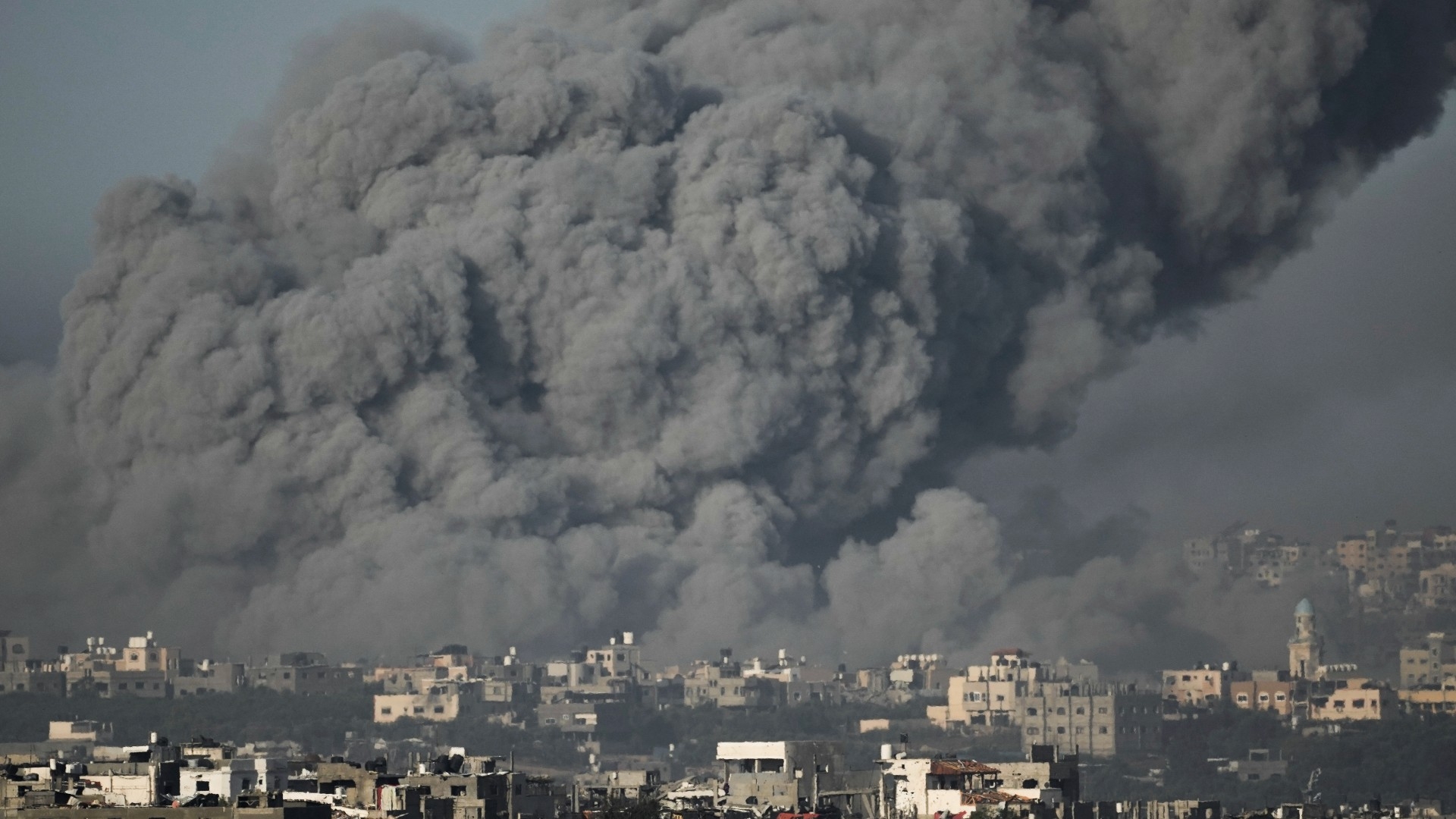 Smoke rises following an Israeli air strike in the Gaza Strip, as seen from southern Israel, 22 November (AP)