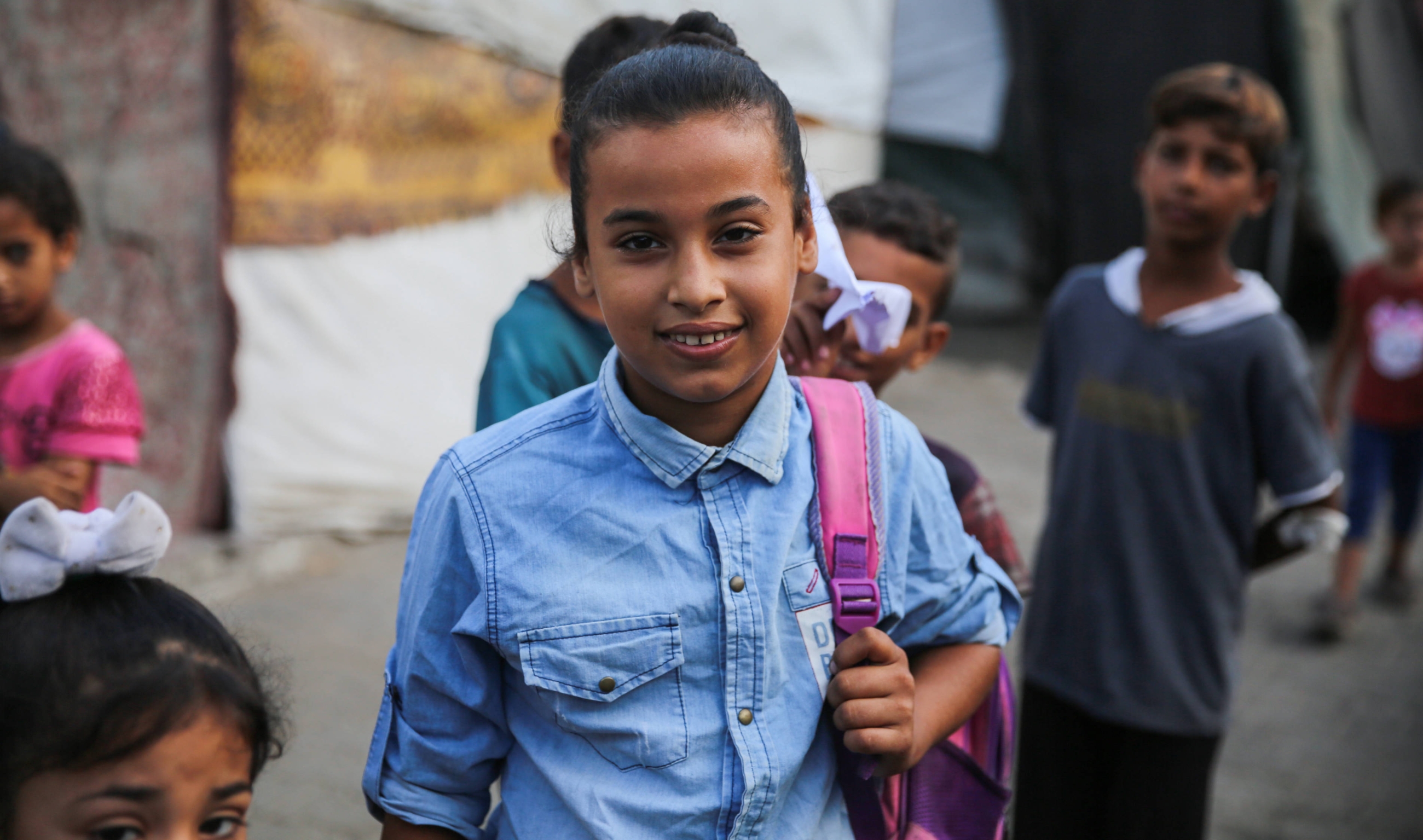 Afnan al-Shenbari, 12, replaced the school books in her backpack with clothes as she and her family fled their home in northern Gaza (Mohammed Hajjar/MEE)