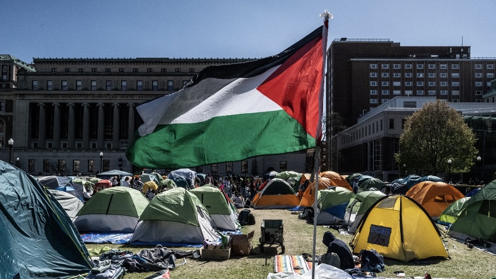 Columbia University students participate in an ongoing pro-Palestinian encampment on their campus, 25 April 2024 (Stephanie Keith/AFP)