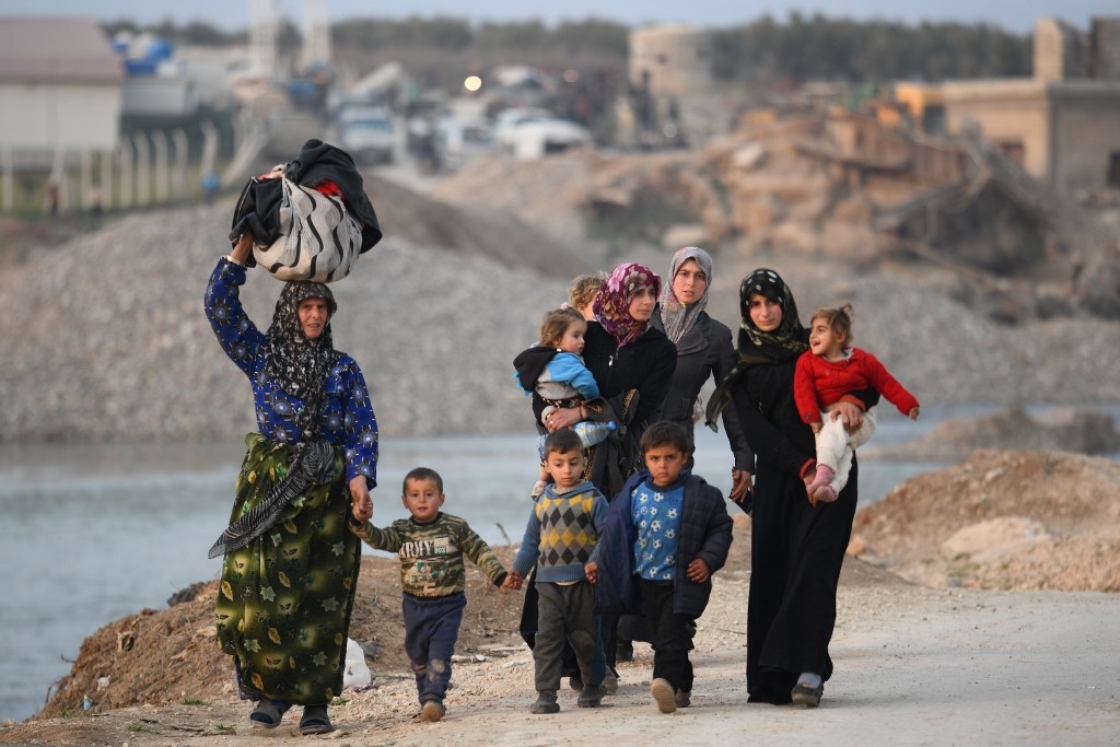 Displaced Syrians arrive at Deir al-Ballut camp in Afrin's countryside, near the border with Turkey