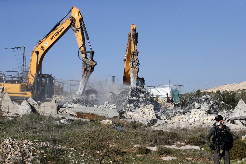 Israeli excavators demolish a Palestinian house in the southern outskirts of Hebron in the occupied West Bank on 3 February (AFP/File photo)