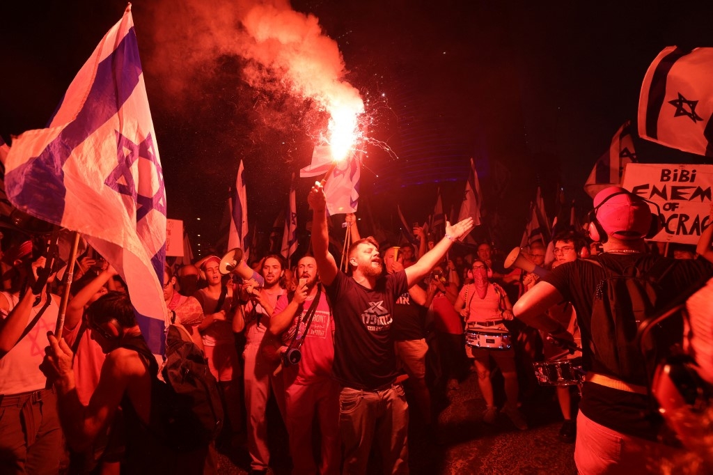 Demonstrators attend a protest against the Israeli government's judicial overhaul bill, in Tel Aviv on 15 July 2023 (AFP)
