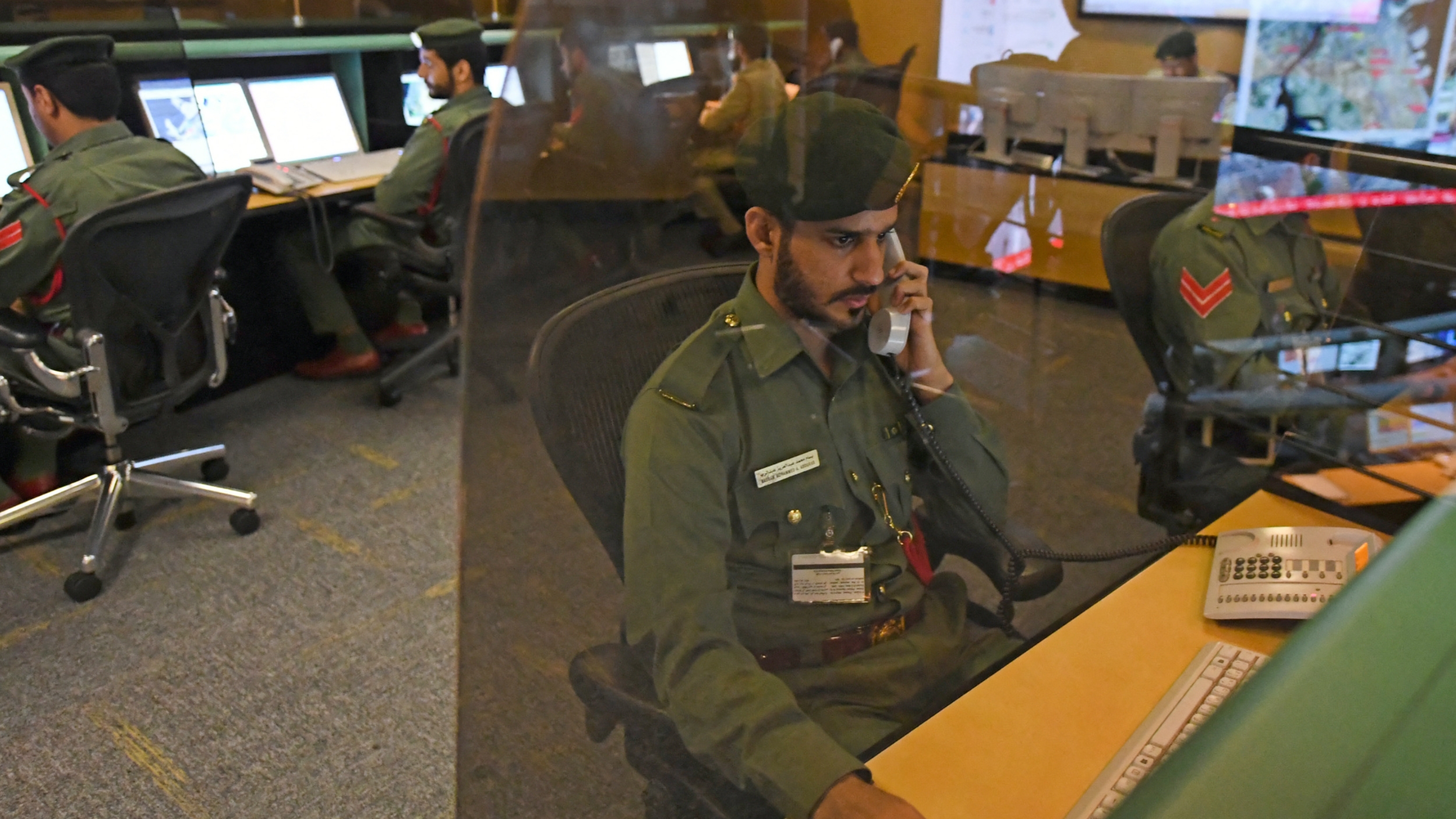 Police officers monitor the streets and receive calls from citizens at the Command and Control Center of Dubai Police in the Gulf emirate, on 24 February 2020