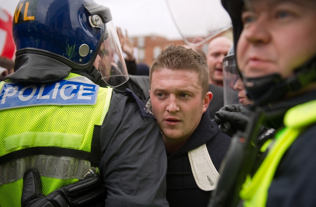 Stephen Lennon (AKA Tommy Robinson) passes between police officers during a far-right rally in Luton, Hertfordshire, on February 5, 2011 (AFP / Leon Neal)