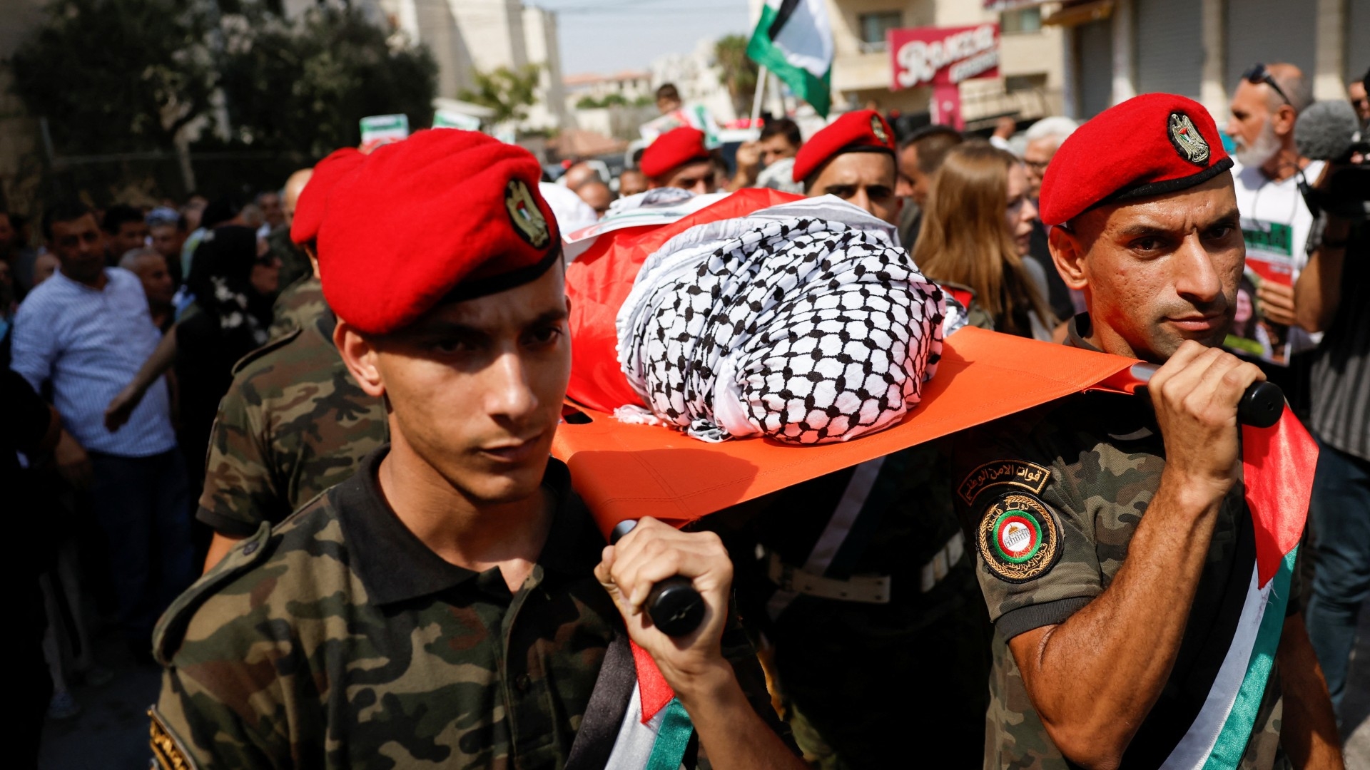 Members of Palestinian security forces carry the body of Aysenur Ezgi Eygi, during a procession honouring her in Nablus, 9 September (Reuters/Mohammed Torokman)