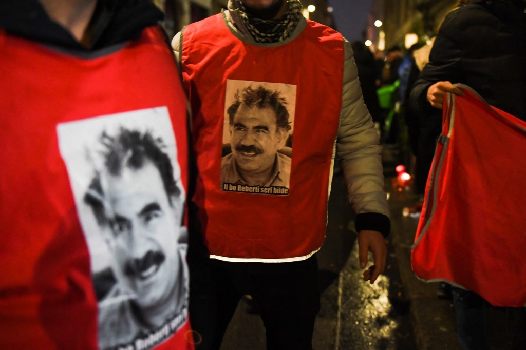 Participants wearing jerseys with the face of Abdullah Ocalan, leader of the Kurdistan Worker's Party (PKK), gather in Paris, on December 24, 2022.  (Julie SEBADELHA /AFP)