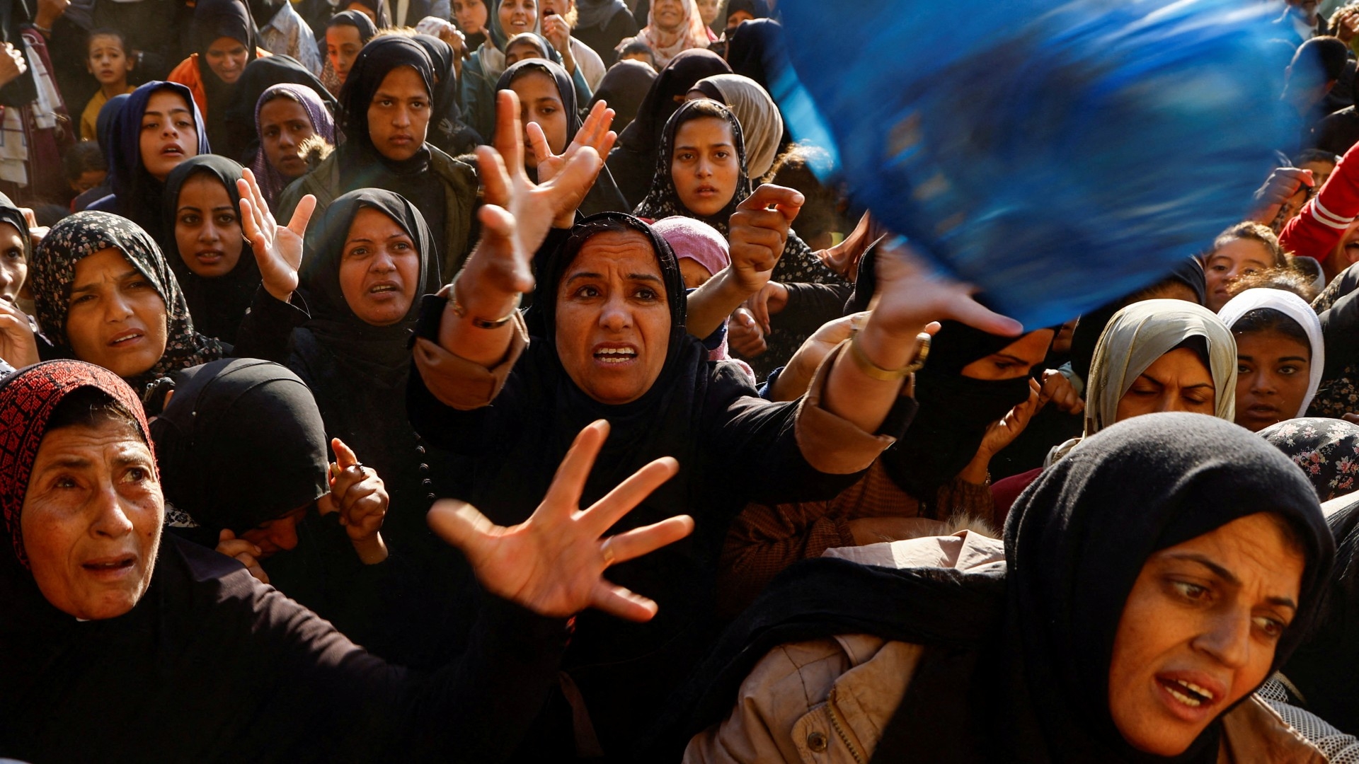 Palestinians gather to buy bread from a bakery in Khan Younis in the southern Gaza Strip on 28 October 2024 (Mohammed Salem/Reuters)