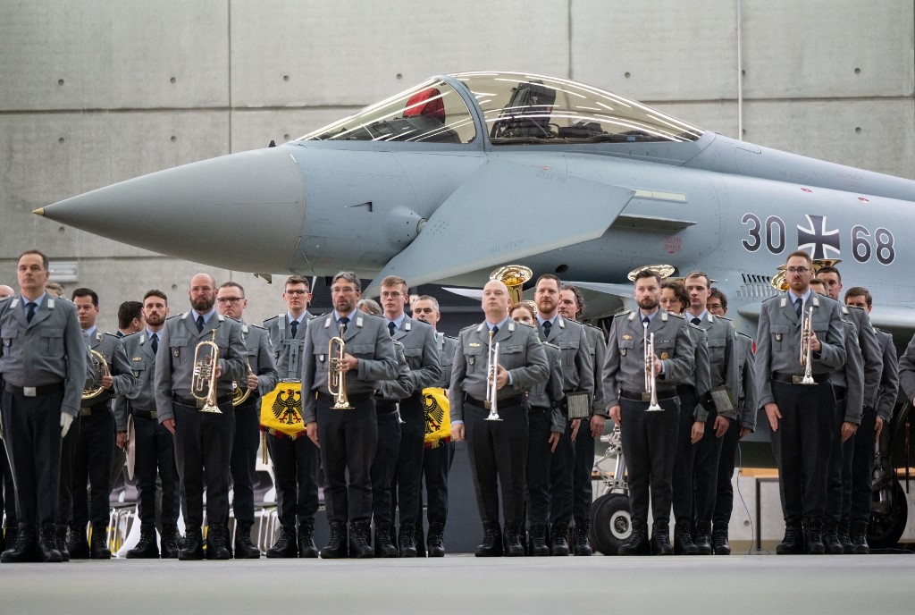 German soldiers take part in a ceremony in front of an Eurofighter jet on 26 February (Lukas Barth-Tuttas/AFP)