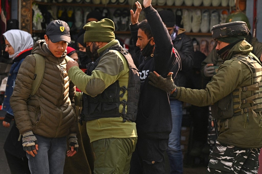 Indian paramilitary troopers search pedestrians ahead of the Republic Day celebrations in Srinagar, Kashmir, 23 January 2023 (AFP)