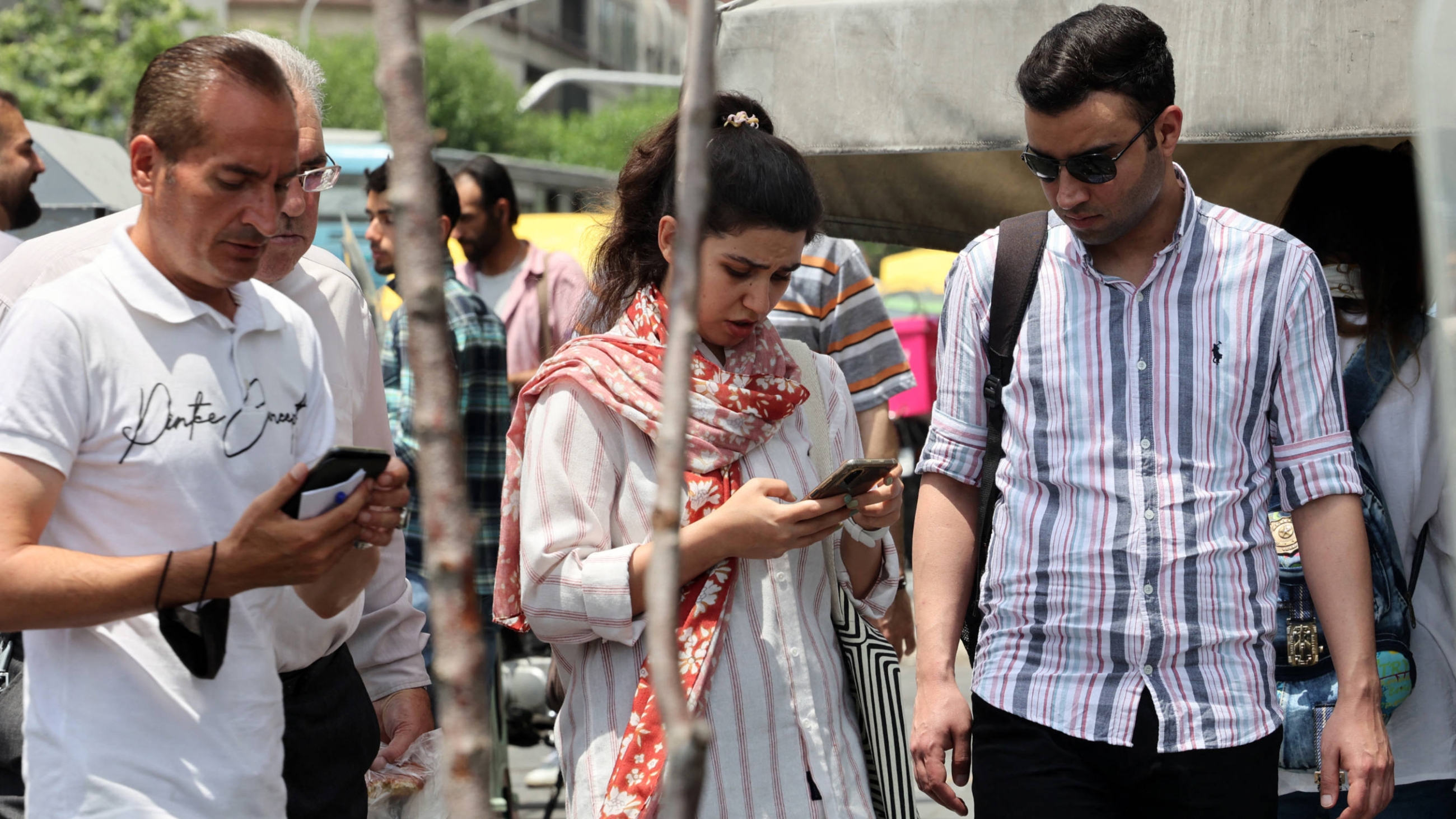 People walk in Tehran on 20 May 2023 (AFP)