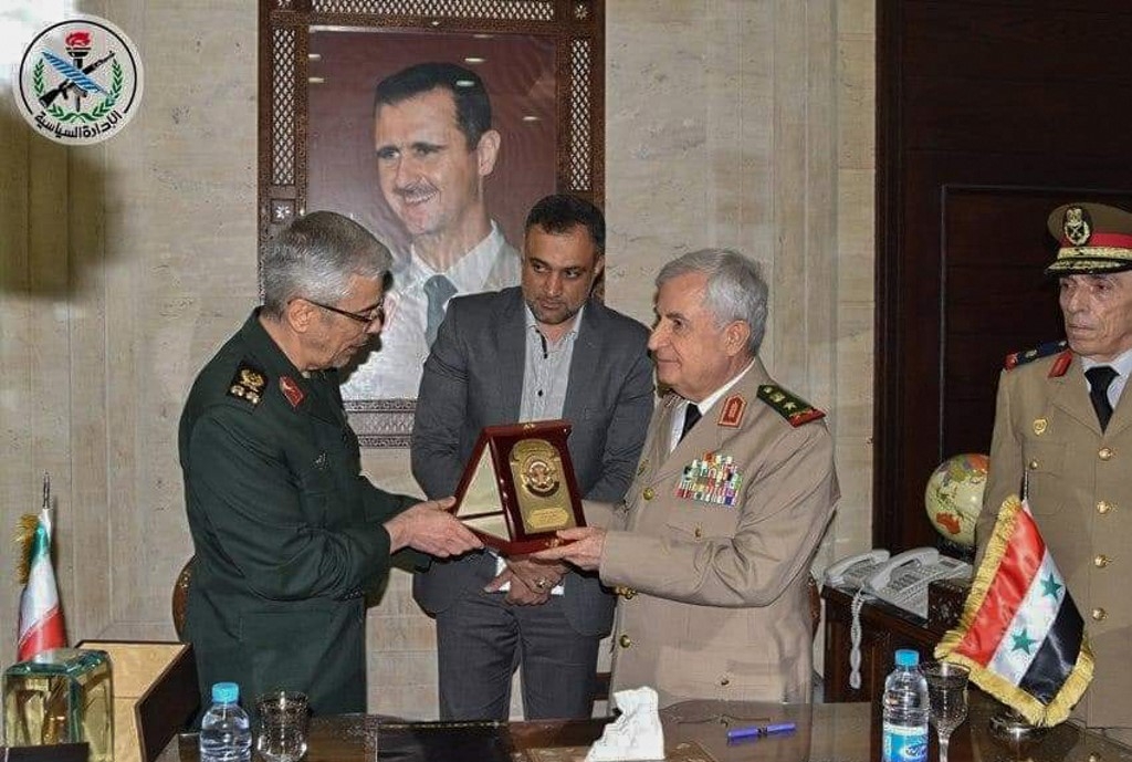 Major General Mohammad Bagheri and Syrian Defense Minister Ali Abdullah Ayyoub exchanging gifts after signing a bilateral military deal in the capital Damascus on 8 July (AFP photo/HO/SANA)