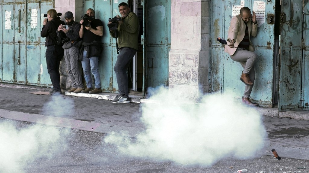 Israeli forces fired rubber-coated bullets at journalists covering confrontations in Hebron on 1 March 2022 (AFP)