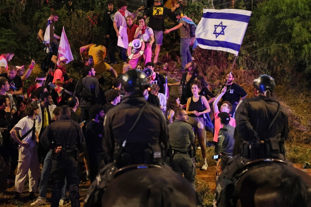 Israeli police surround protesters during a demonstration against the government's judicial reform bill, in Tel Aviv on 15 April 2023 (AFP)