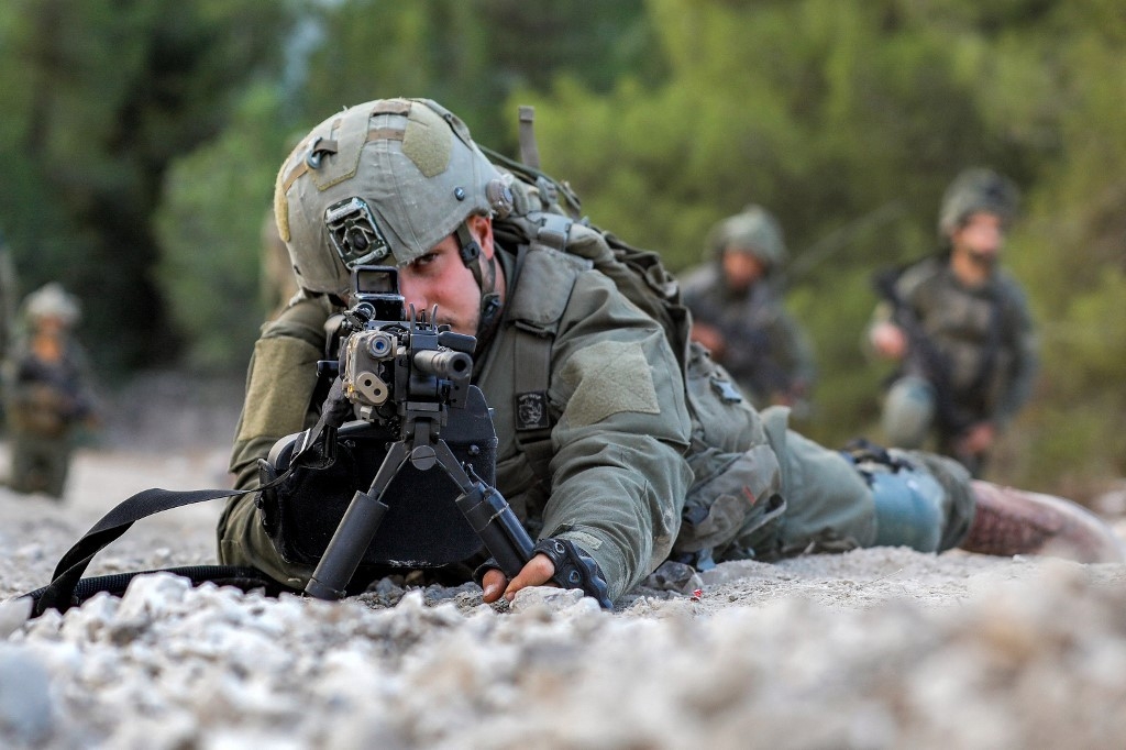 An Israeli army soldier in northern Israel near the border with Lebanon earlier this week (AFP)