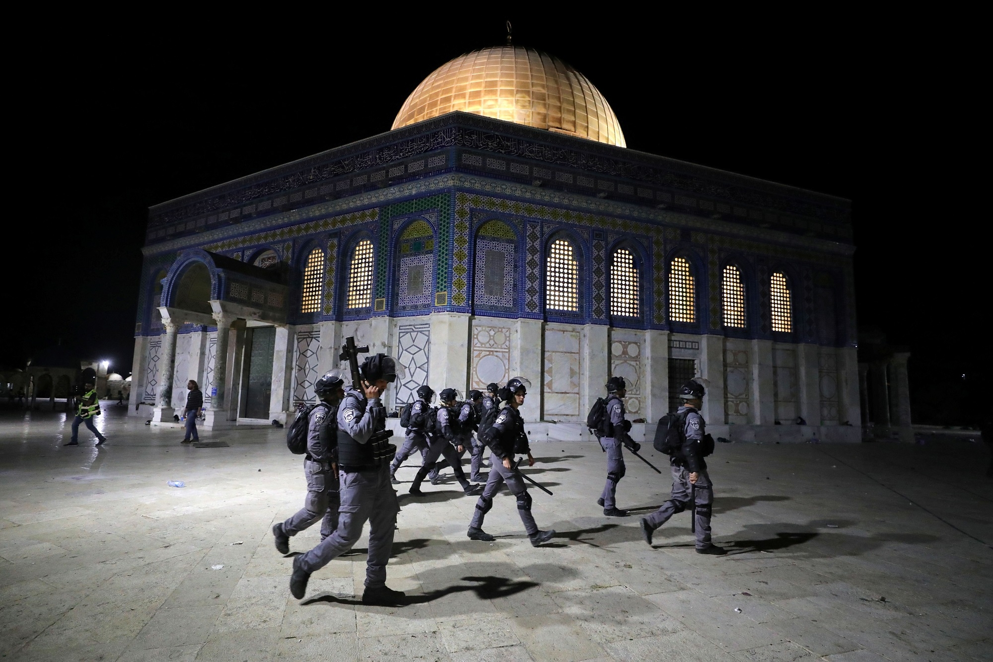 Israeli police walk near the Dome of the Rock during a crackdown on Palestinian protesters 
