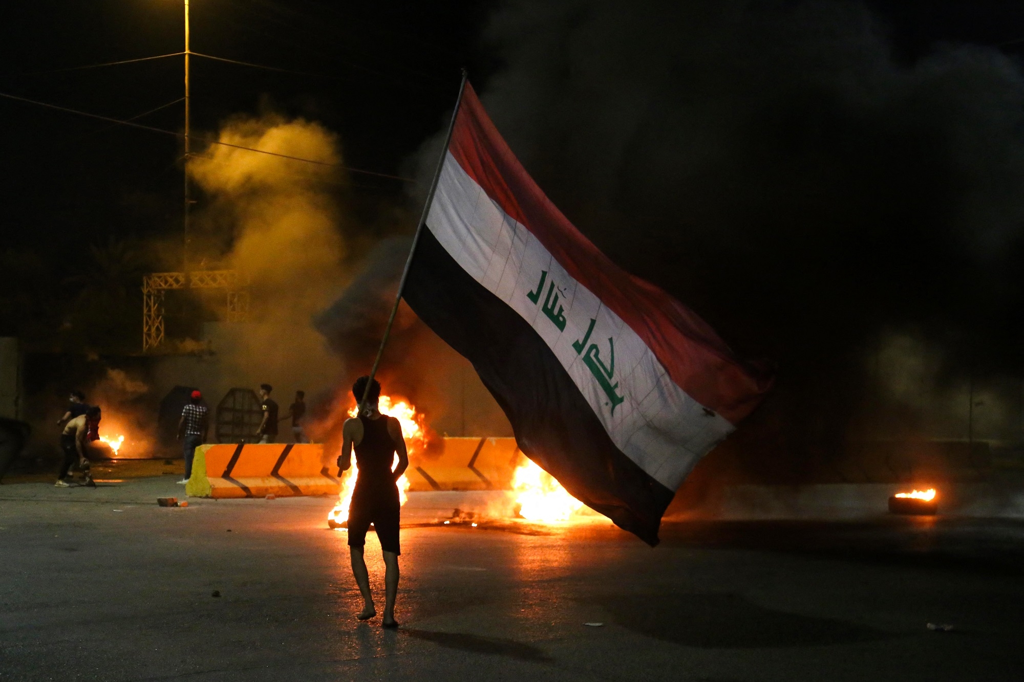 Iraqi protesters burn tyres in front of the Karbala governorate headquarters on Sunday 