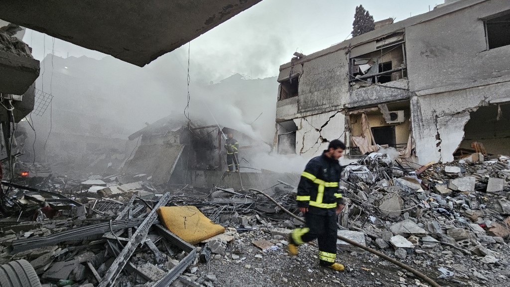 A firefighter battles a blaze at the site of an Israeli airstrike that targeted the Shiyah neighborhood in Beirut’s southern suburbs on November 26, 2024, amid the ongoing war between Israel and Hezbollah (AFP)