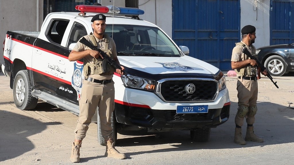 Libyan security forces stand guard during a handover ceremony in the capital Tripoli on 26 August (Mahmud Turkia/AFP)