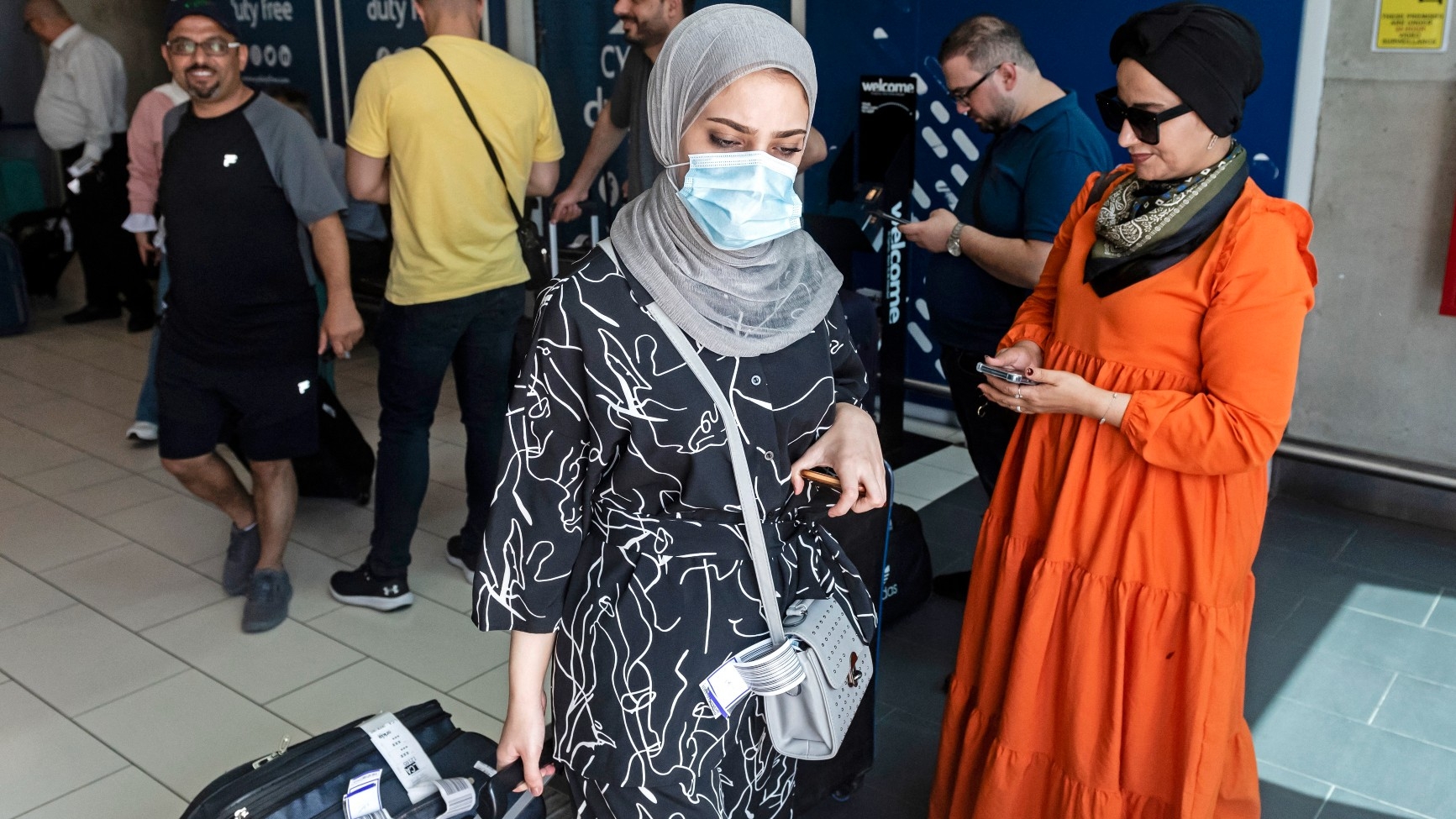 Palestinians leave Larnaca International Airport after arriving aboard the first flight from Israel's Ramon airport, in Cyprus on 22 August, 2022 (AFP)