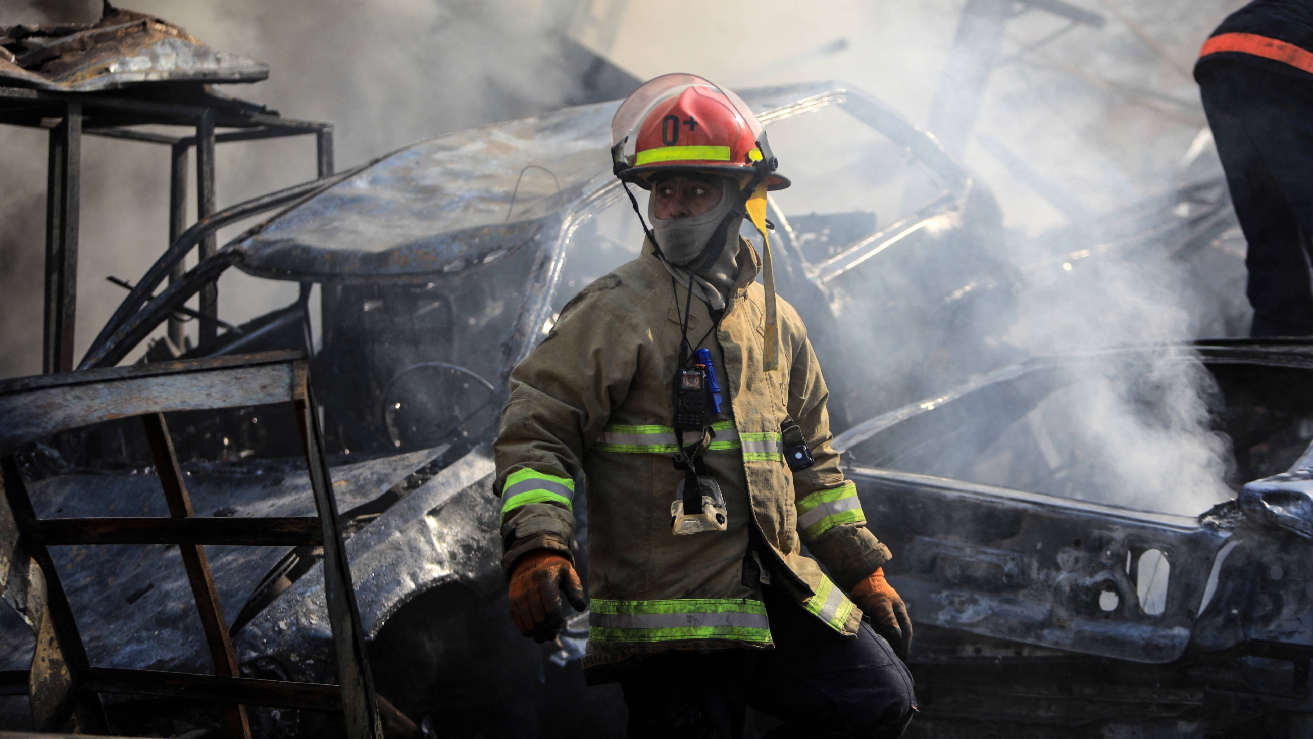 A firefighter stands amid the smouldering debris at the site of overnight Israeli air strikes targeting Kafaat in Beirut's southern suburbs on 1 November 2024 (AFP)