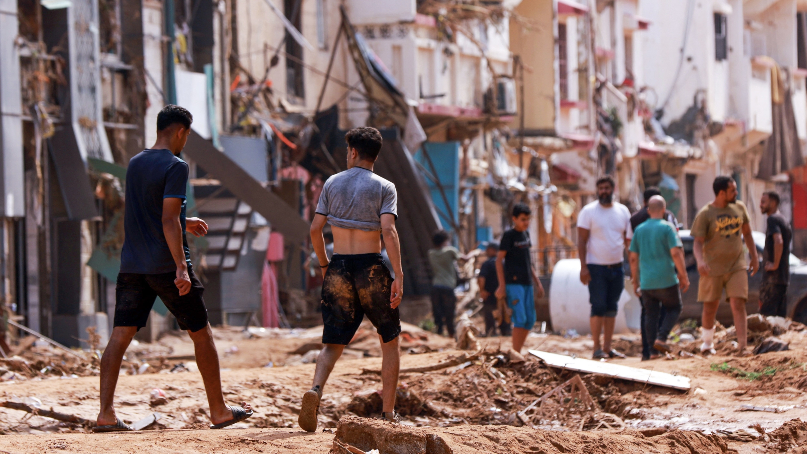People check an area damaged by flash floods in Derna, eastern Libya, on September 11, 2023 (AFP)