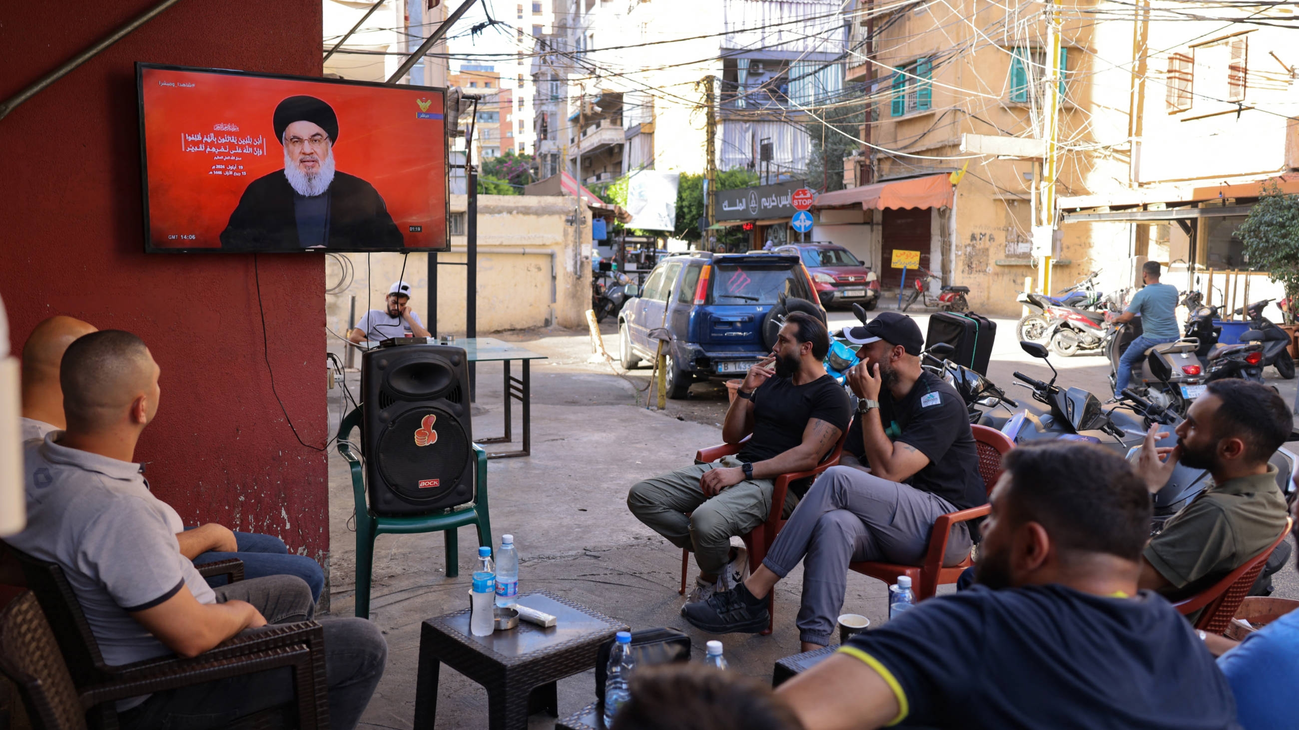 People watch on a television screen Hezbollah leader Hassan Nasrallah deliver a speech, at a cafe in the Shiyah neighbourhood of Beirut's southern suburbs on September 19, 2024 (AFP)