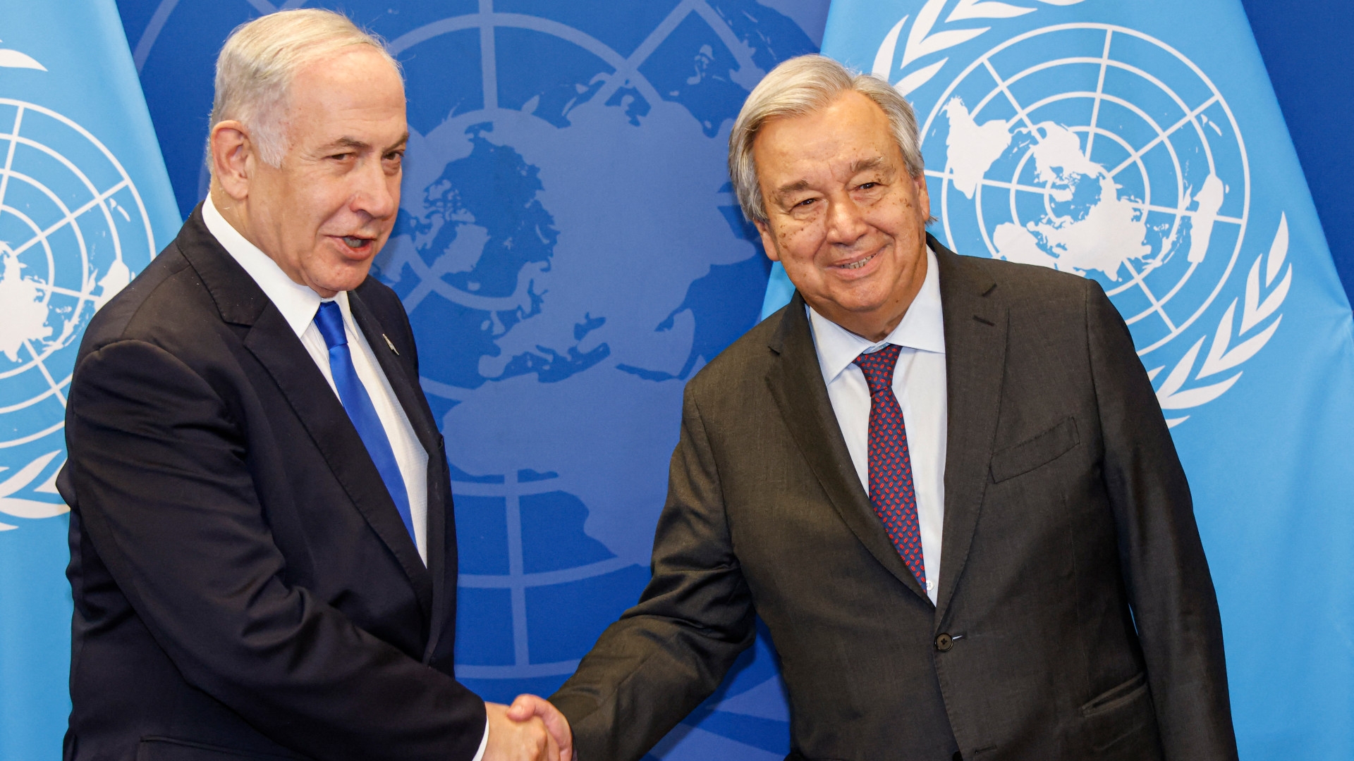 Secretary-General Antonio Guterres shakes hands with Israeli Prime Minister Benjamin Netanyahu at the United Nations Headquarters in New York City last week (AFP)