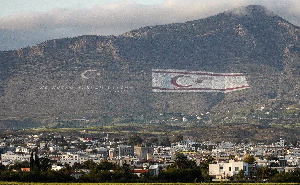 The Kyrenia mountain range north of the divided Cypriot capital, with the flags of Turkey and the Turkish Republic of Northern Cyprus (TRNC) painted on the mountain overlooking Nicosia (Roy ISSA/AFP)