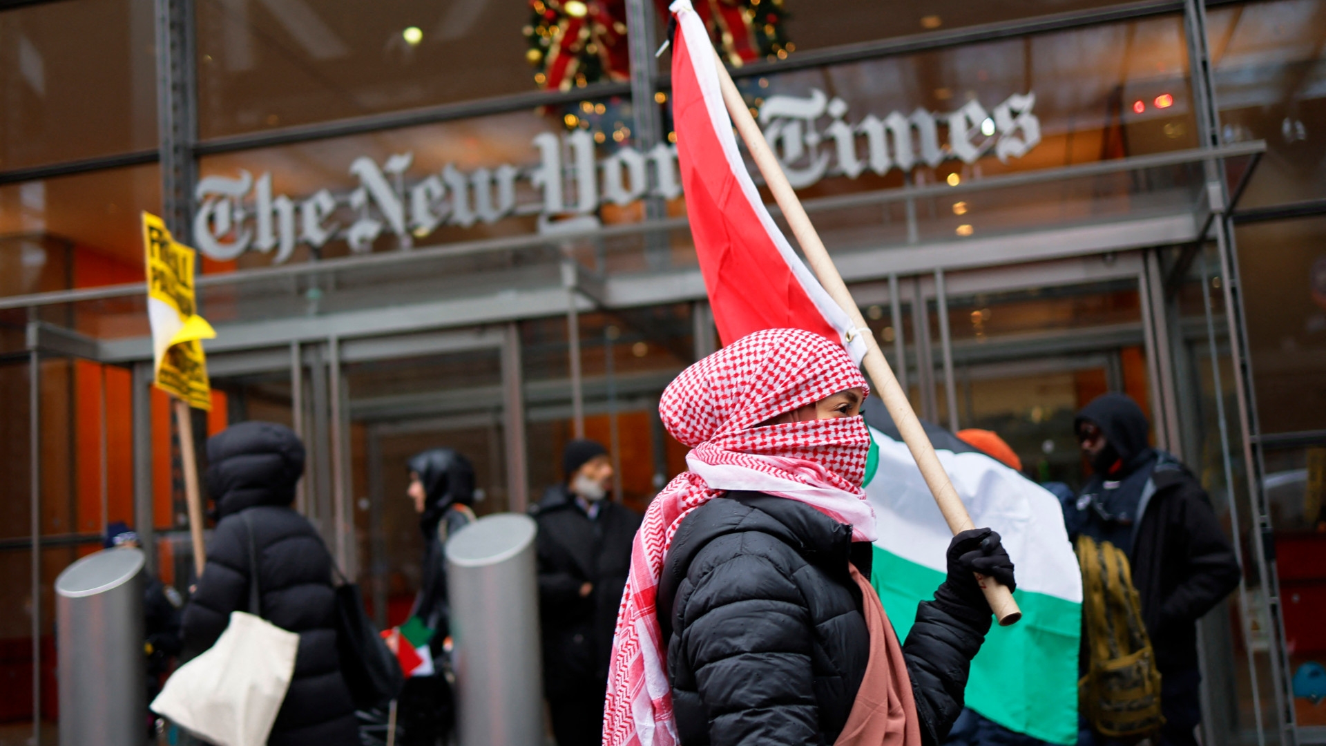 Pro-Palestinian protesters gather outside of The New York Times building to protest the newspaper’s coverage of the Israel-Palestine war on 11 December 2023 in New York City (Michael M. Santiago/Getty via AFP)