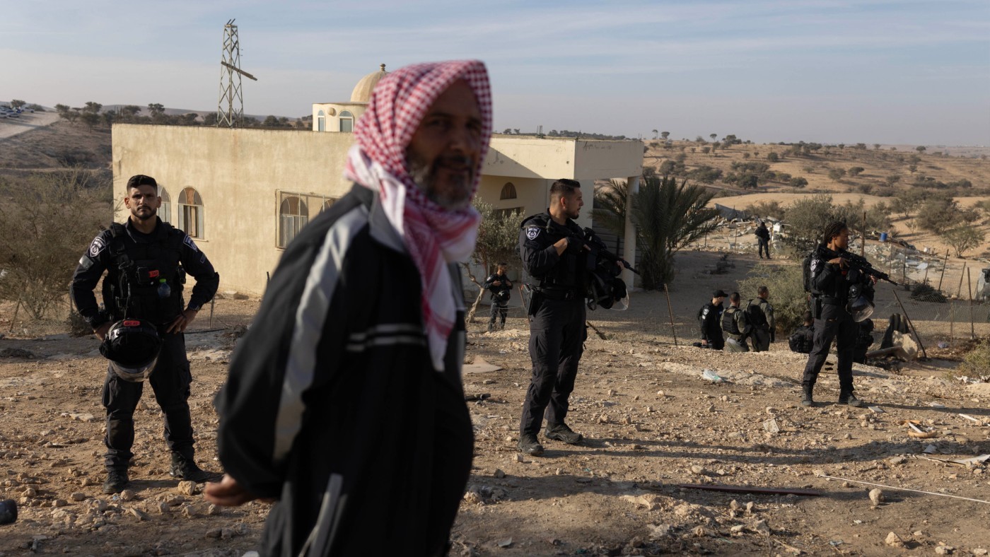 A Palestinian resident of Umm al-Hiran looks on as his village is destroyed (Oren Ziv/MEE)