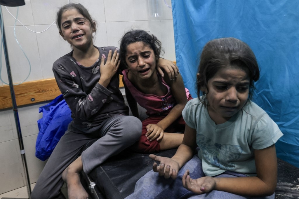 Palestinian children injured in an Israeli air strike await treatment at the Nasser hospital in Khan Yunis in the southern of Gaza Strip, on October 17, 2023
